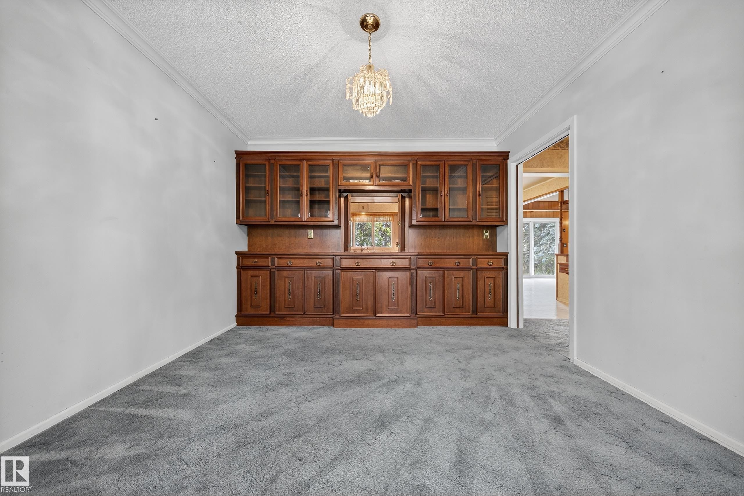 Built-in wood cabinetry featuring glass-front uppers and solid wood base storage, accented by a centered mirror - 707 65 Avenue, Edmonton, AB