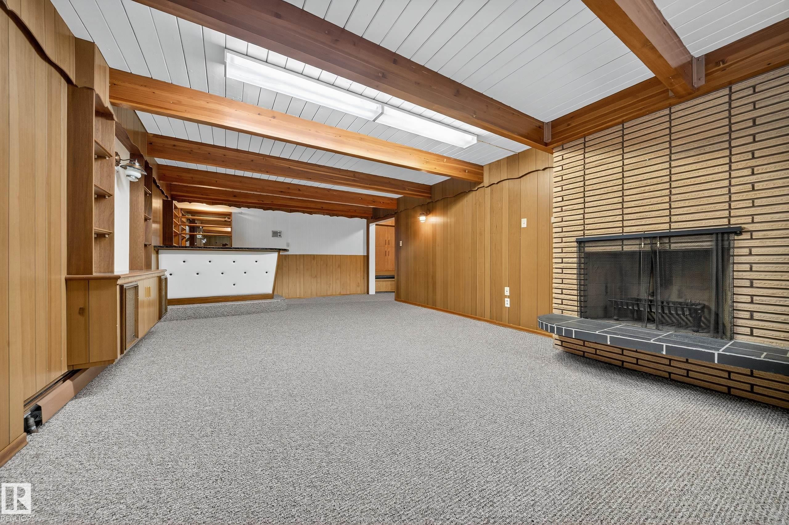 Recessed fireplace with a black metal screen and hearth - 707 65 Avenue, Edmonton, AB