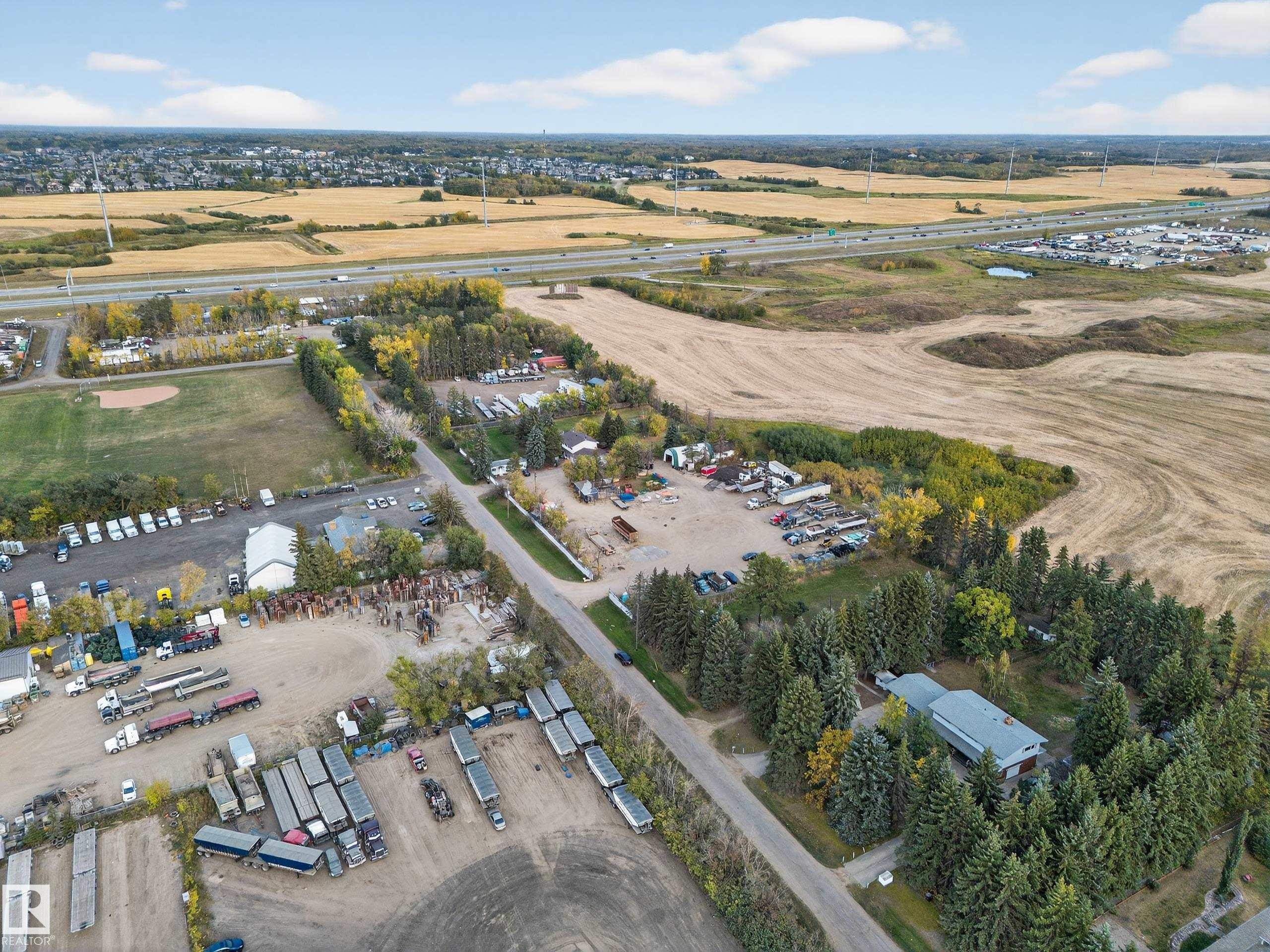 Aerial perspective showcasing a property surrounded by mature evergreen trees - 707 65 Avenue, Edmonton, AB