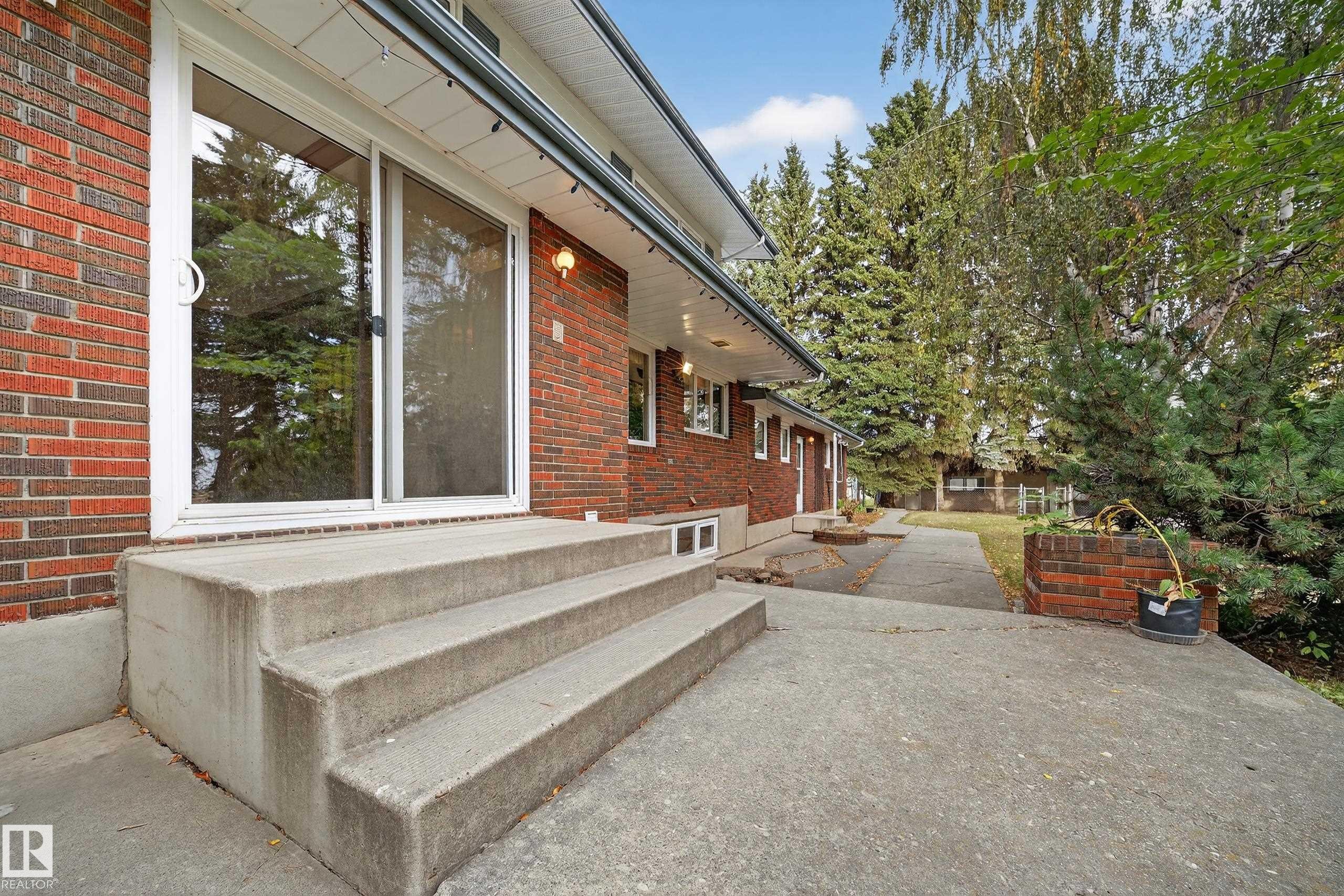 Brick exterior with white trim - 707 65 Avenue, Edmonton, AB