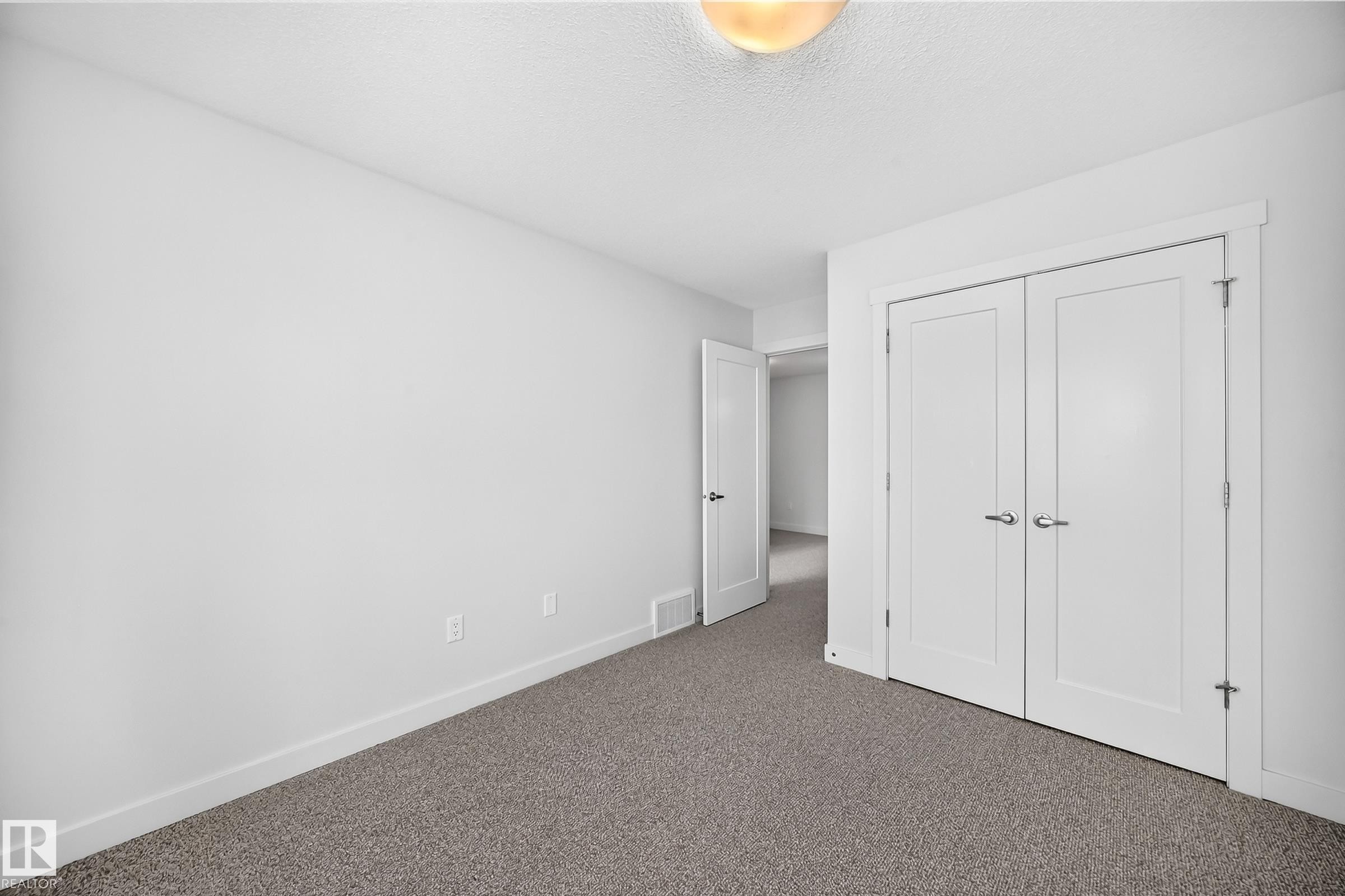 Room with neutral-toned carpet flooring and white walls - 2433 Glenridding Boulevard, Edmonton, AB