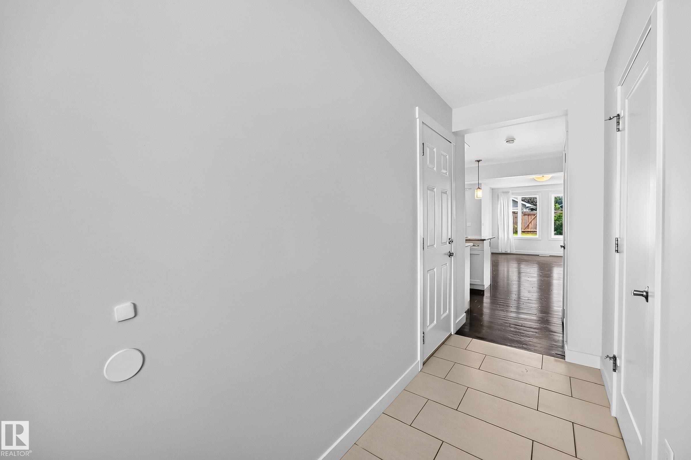 Entryway featuring light tile flooring and crisp white trim - 2433 Glenridding Boulevard, Edmonton, AB