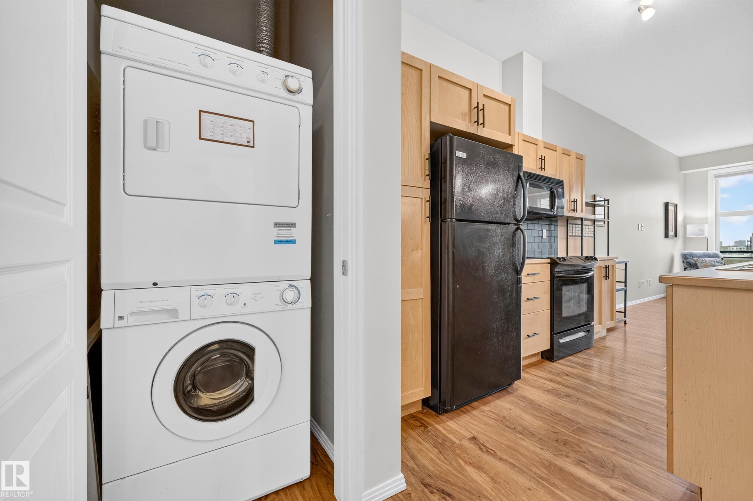 Dedicated laundry closet featuring a stacked washer and dryer - #410 10531 117 St Nw, Edmonton, AB