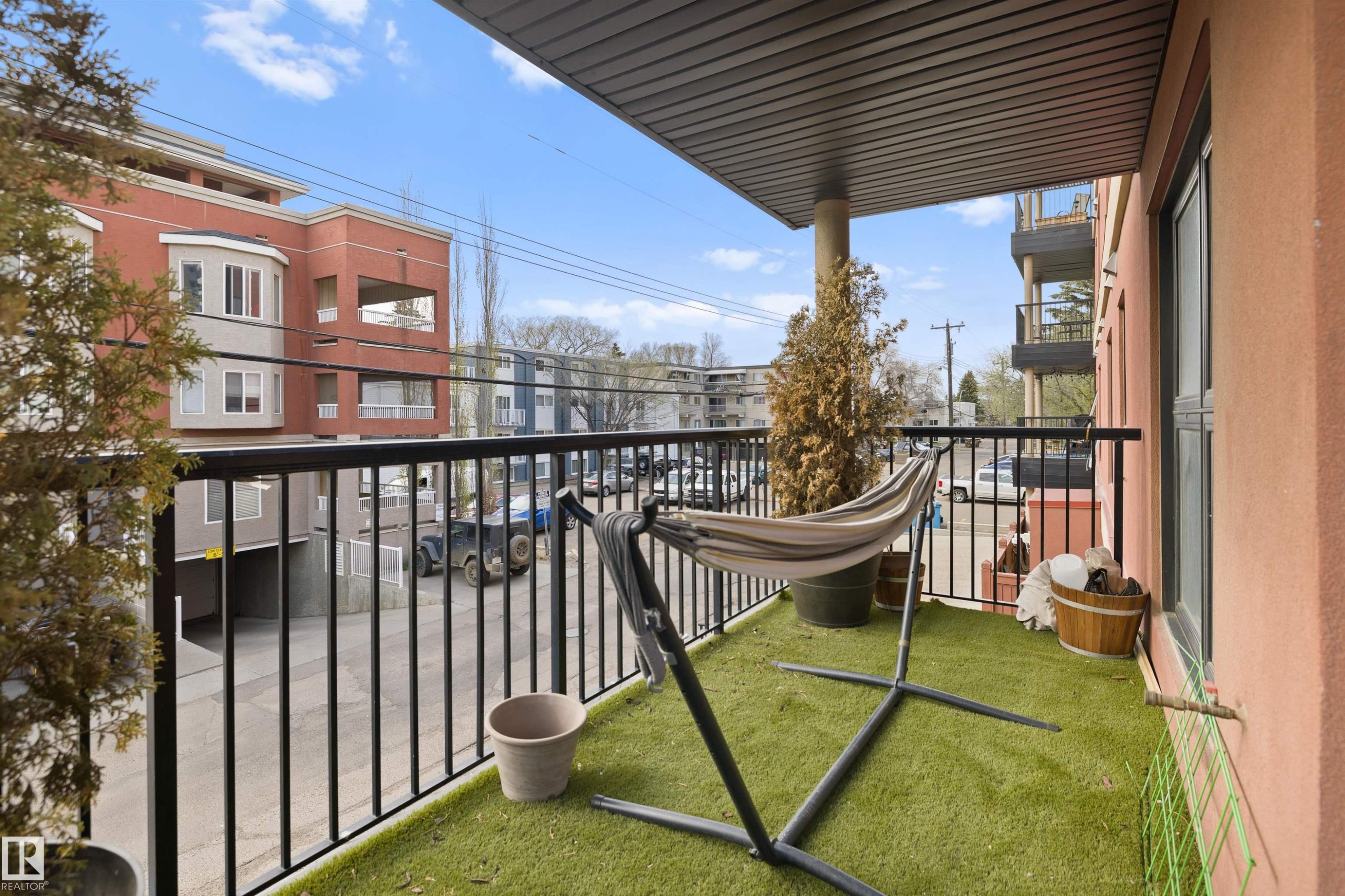 Private balcony featuring artificial turf flooring and a black metal railing - #206 10232 115 St Nw, Edmonton, AB