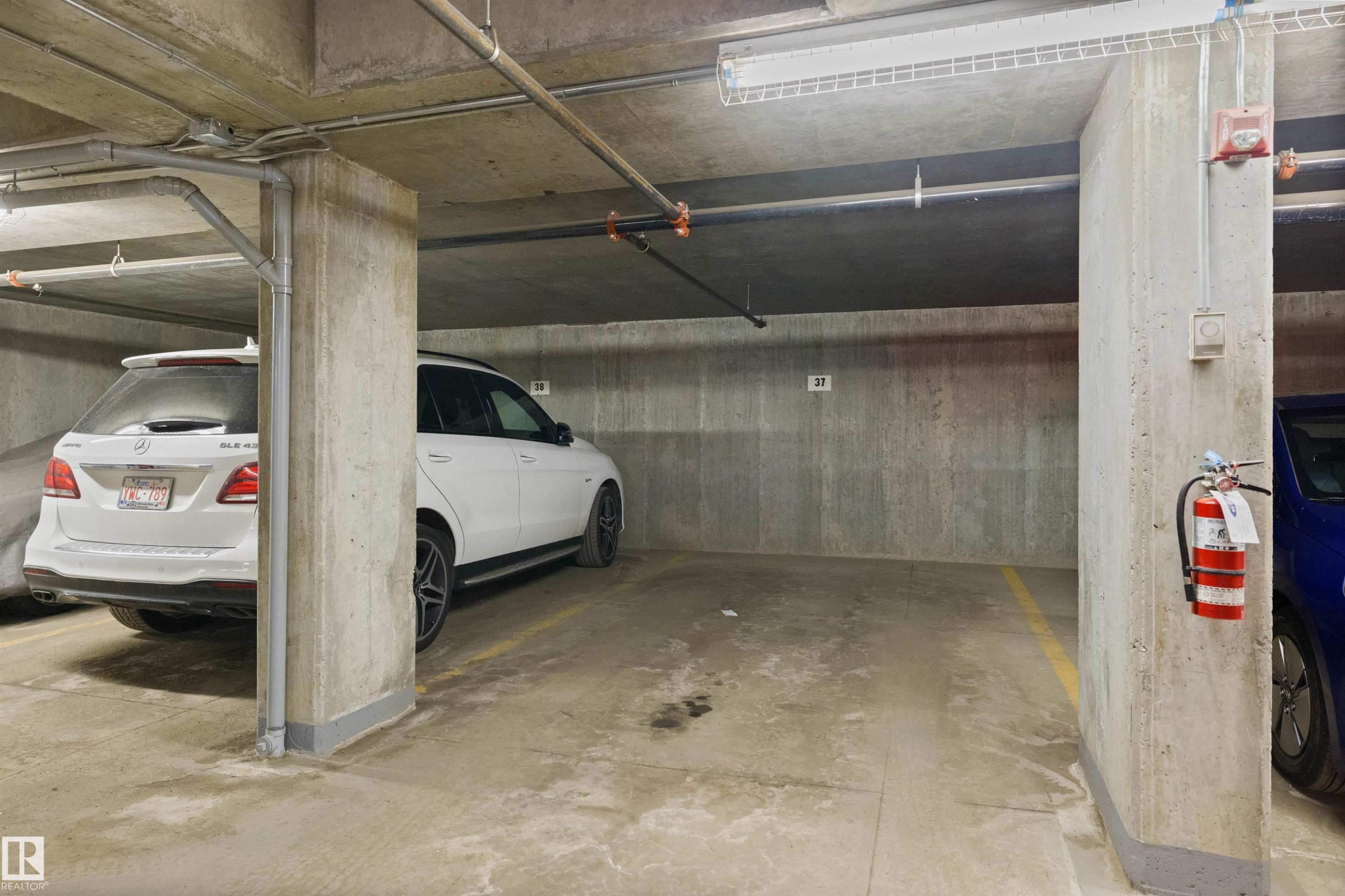 Dedicated parking space within a concrete subterranean garage - #206 10232 115 St Nw, Edmonton, AB