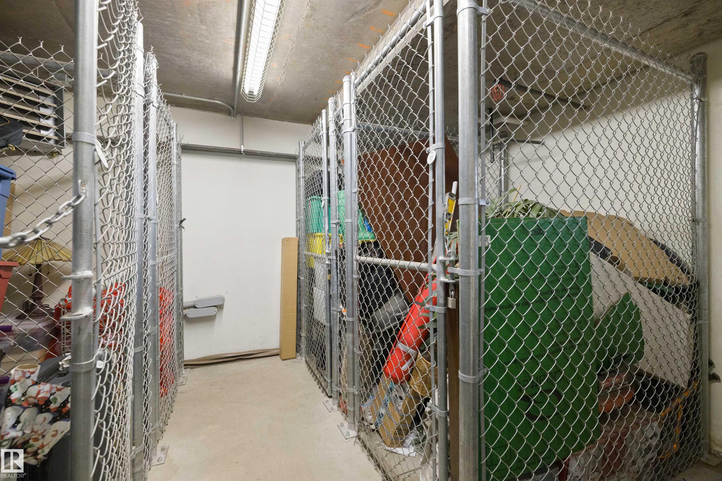 Dedicated storage units featuring chain-link construction and concrete flooring - #206 10232 115 St Nw, Edmonton, AB