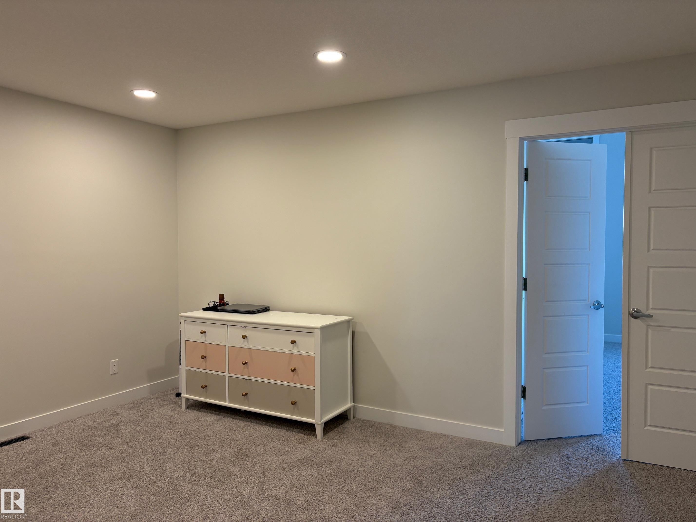 Neutral tone walls with recessed lighting and grey carpet flooring - 9952 227 Street, Edmonton, AB