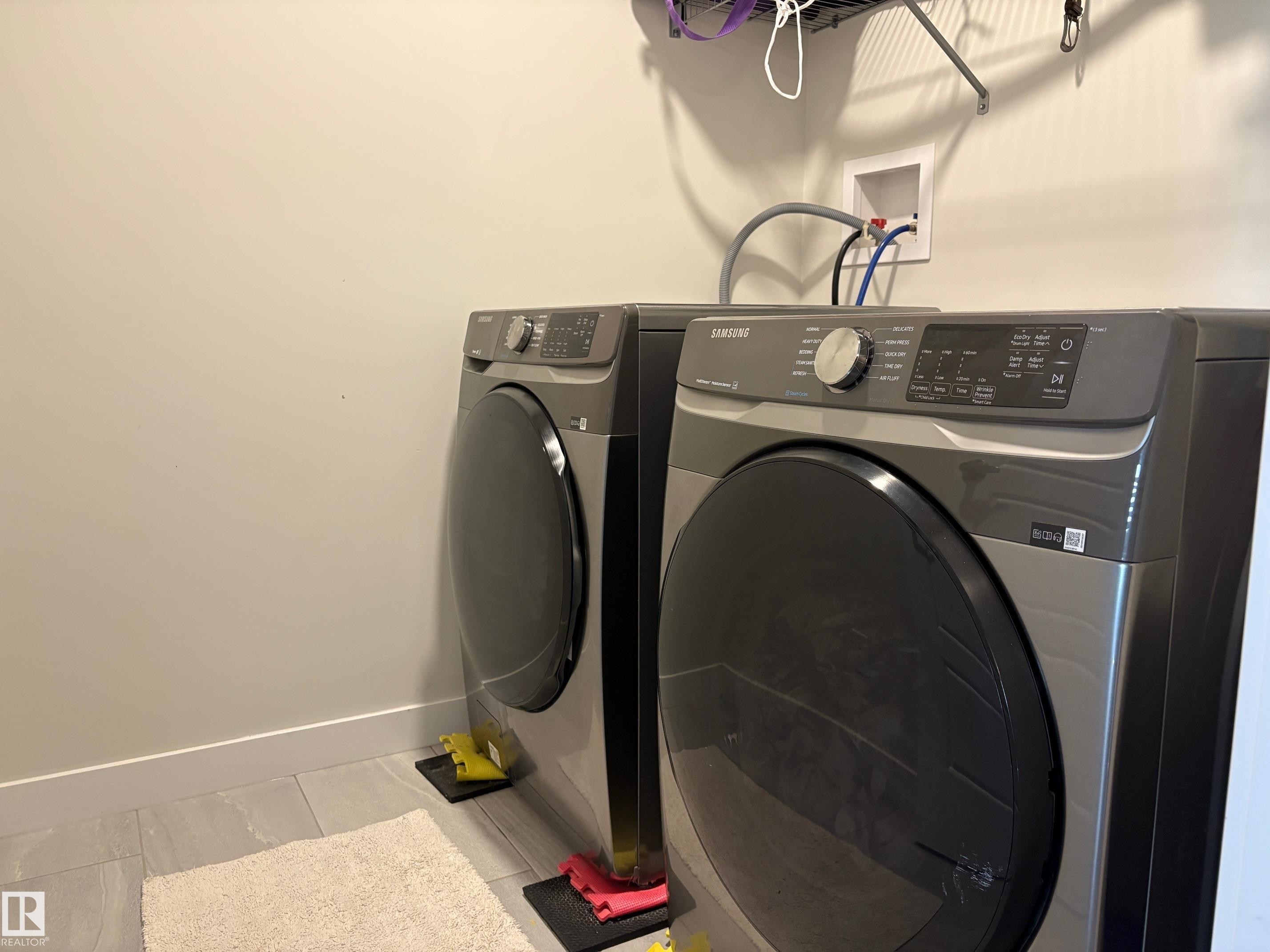 Dedicated laundry area featuring tile flooring and neutral wall tones - 9952 227 Street, Edmonton, AB