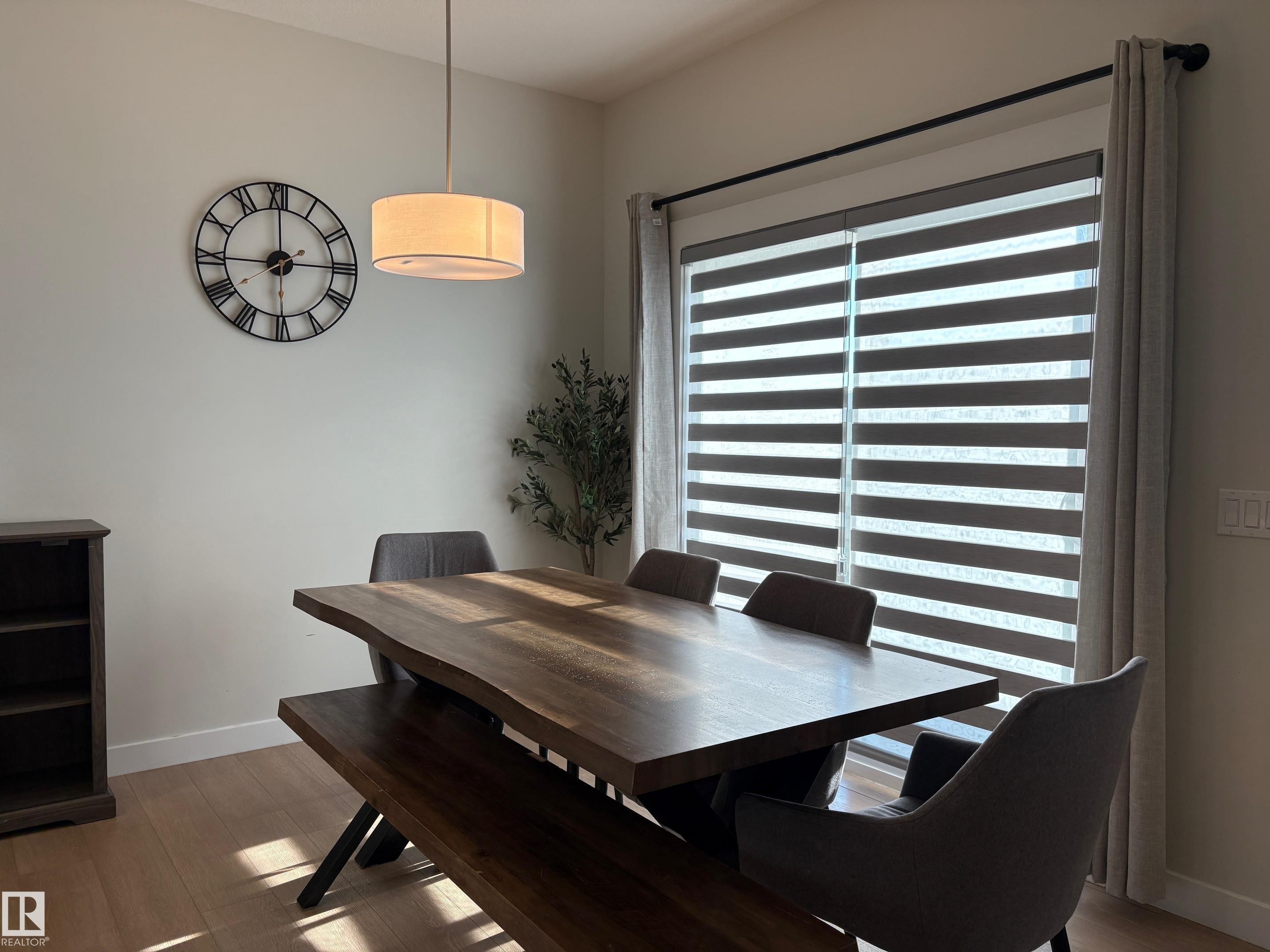 Spacious room featuring light-toned walls and wood-finish flooring - 9952 227 Street, Edmonton, AB