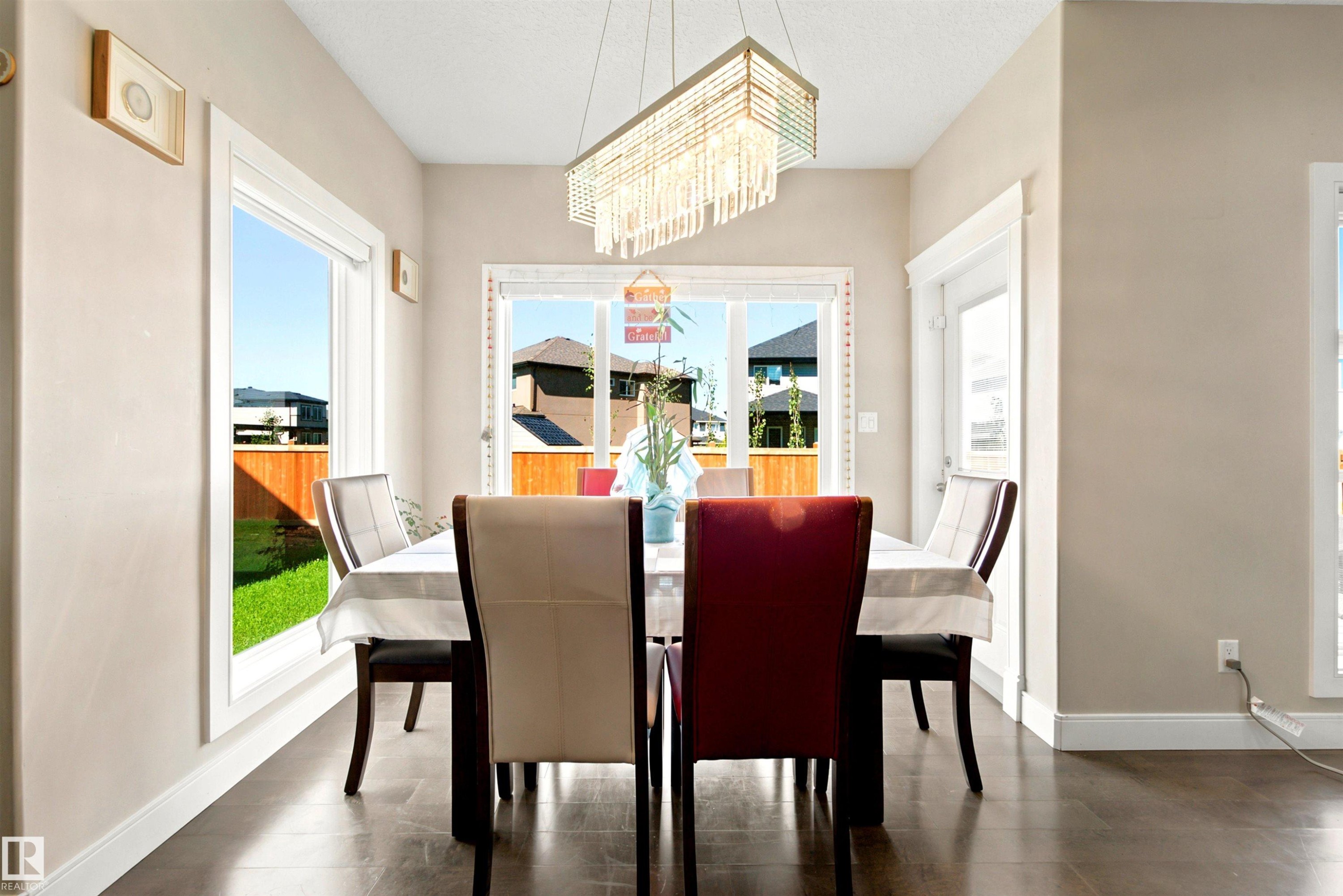 Dining area featuring dark wood-finish flooring and neutral wall tones - 5110 Rue Eaglemont, Beaumont, AB