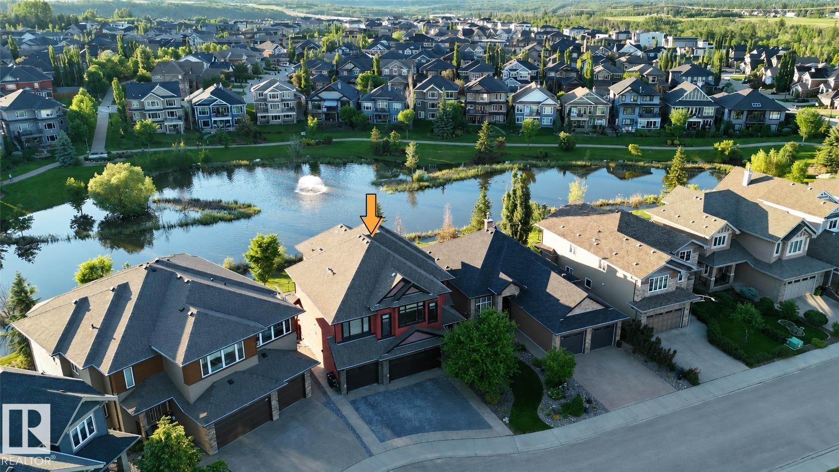 Two-story residence featuring a multi-gabled roofline, red-toned siding, and a prominent front-facing window bay - 3438 West Landing Landing, Edmonton, AB