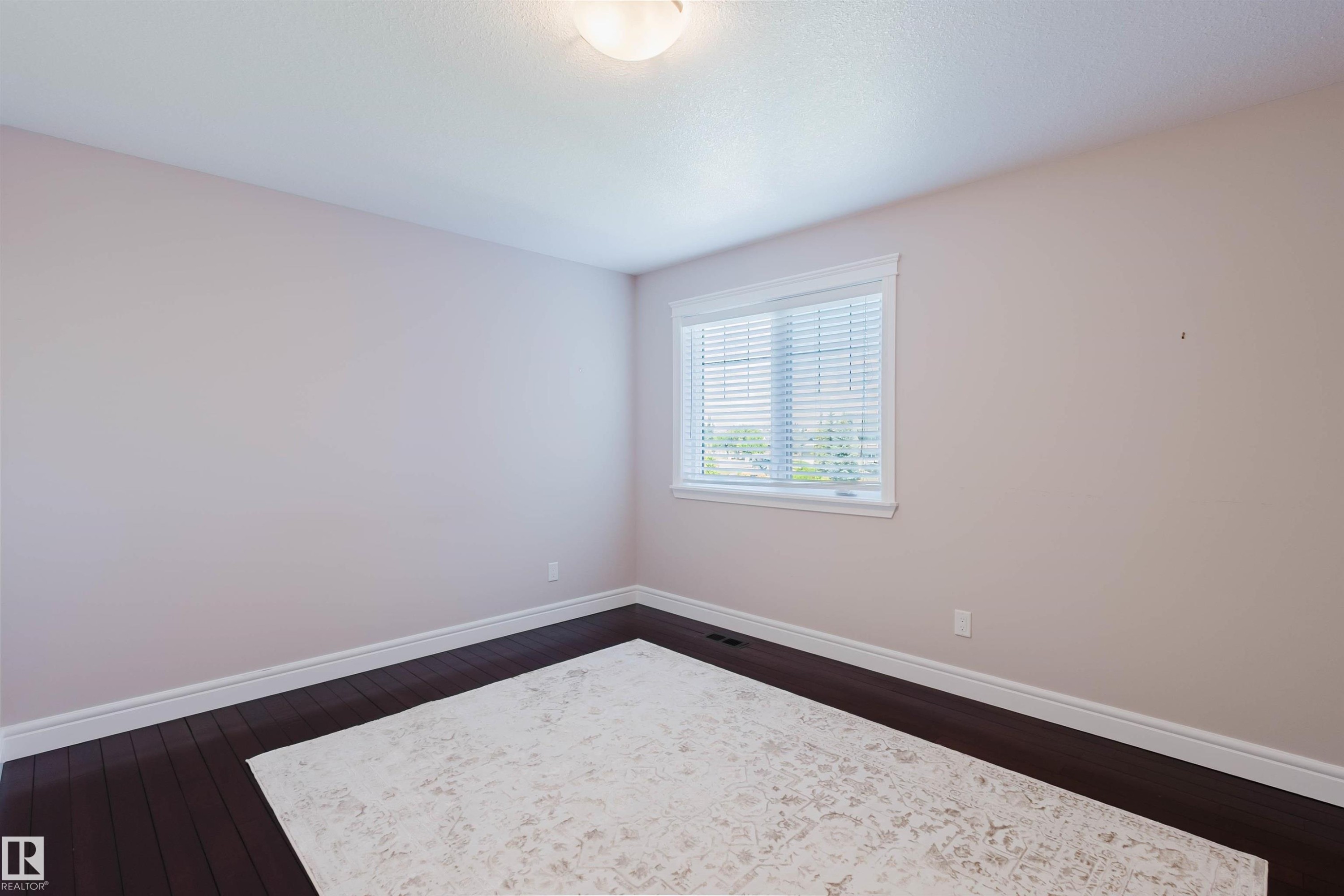 Room featuring dark wood-finish flooring, light-toned walls, and a window with horizontal blinds - 3438 West Landing Landing, Edmonton, AB