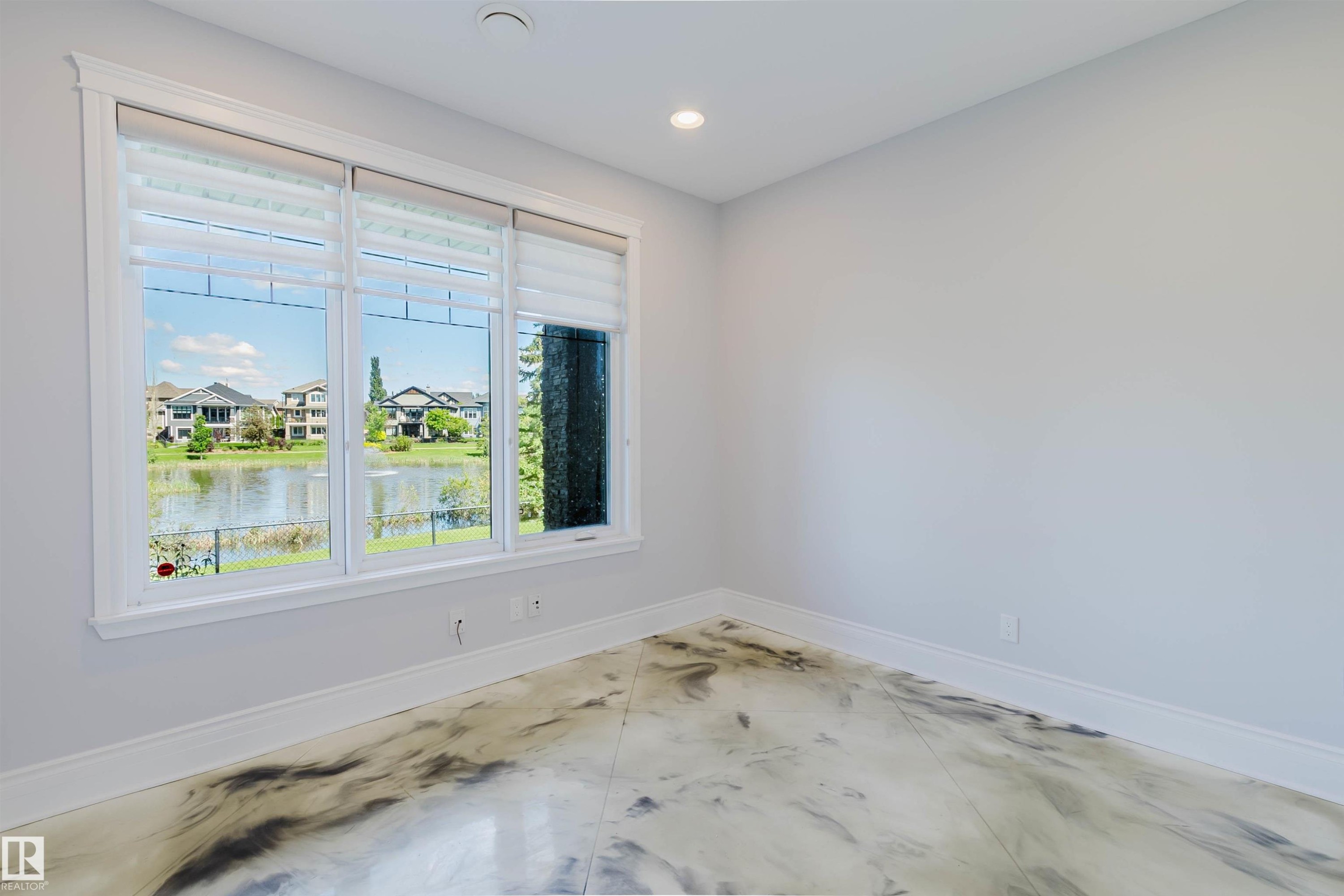 Expansive triple window overlooking a pond and neighboring properties - 3438 West Landing Landing, Edmonton, AB