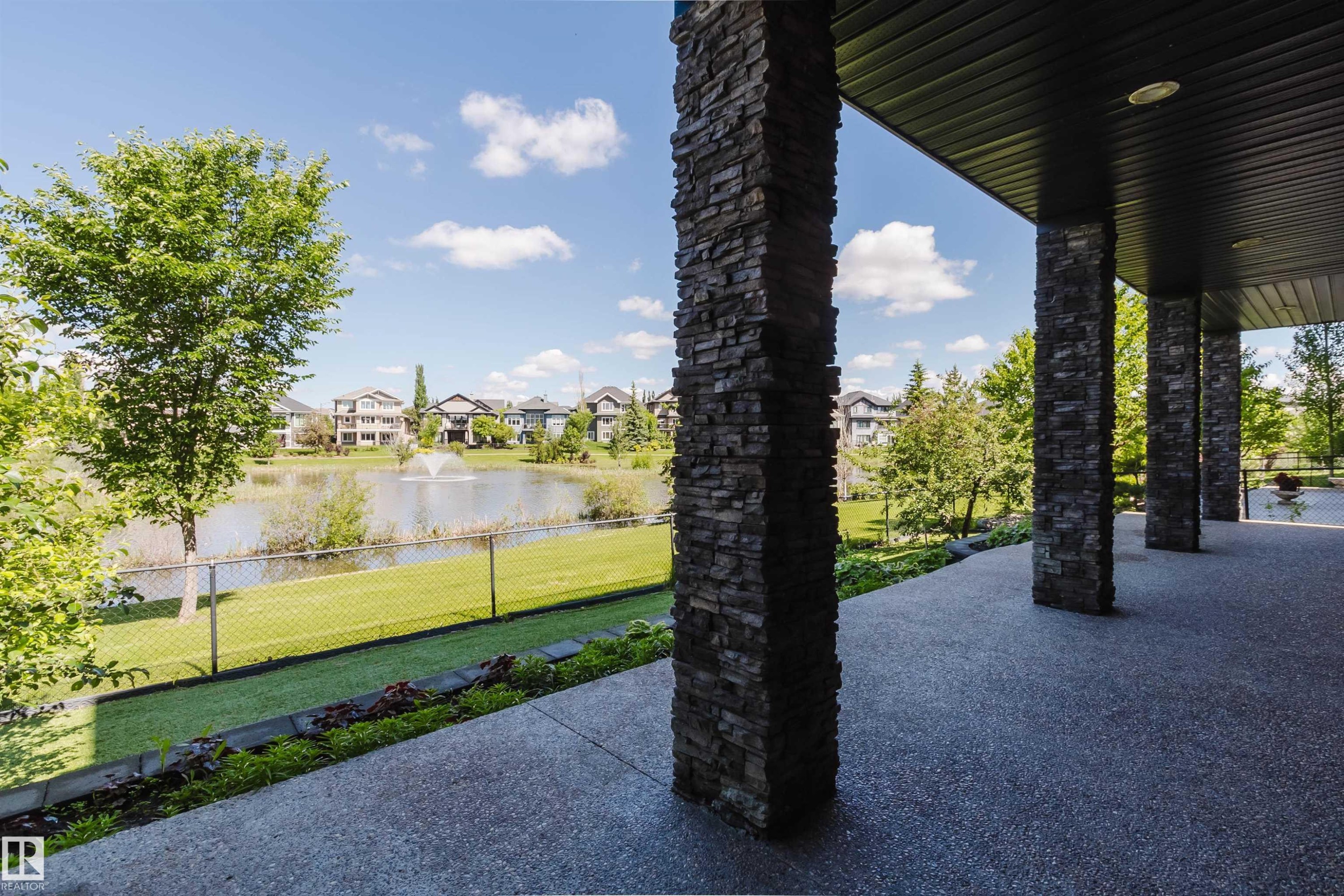 Covered patio featuring stacked stone columns and an exposed aggregate surface - 3438 West Landing Landing, Edmonton, AB