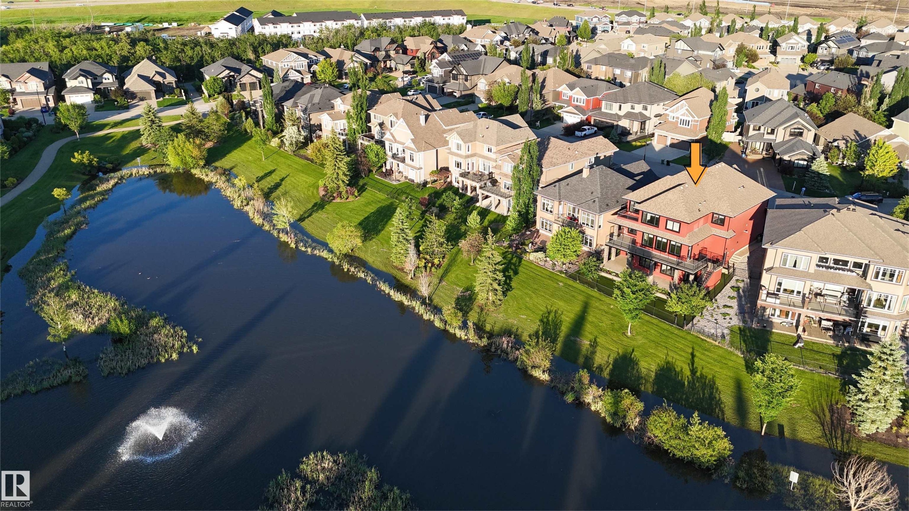 Red multi-story residence featuring multiple balconies and a sloped roof - 3438 West Landing Landing, Edmonton, AB