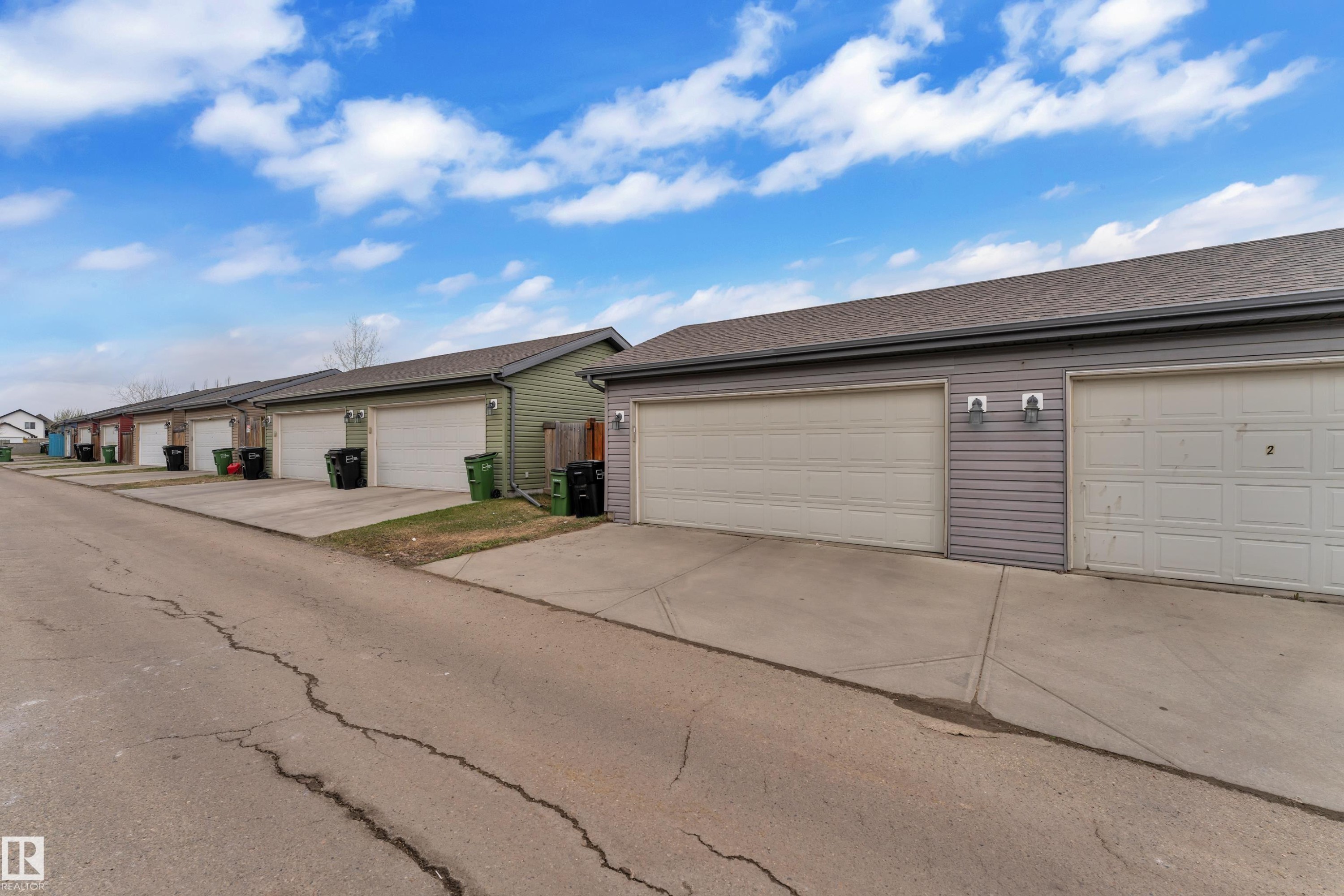 Row of attached garage units featuring concrete driveways - 2143 32 Street, Edmonton, AB