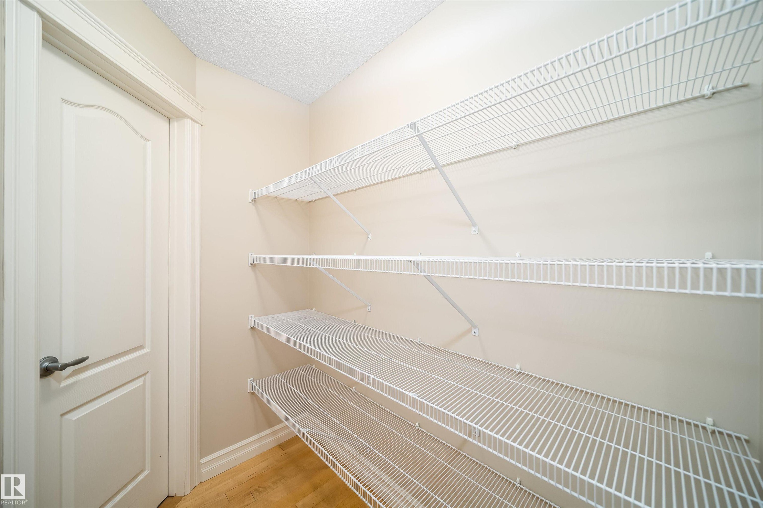 Interior storage closet featuring multiple wire shelving units - 11312 13 Ave Sw, Edmonton, AB