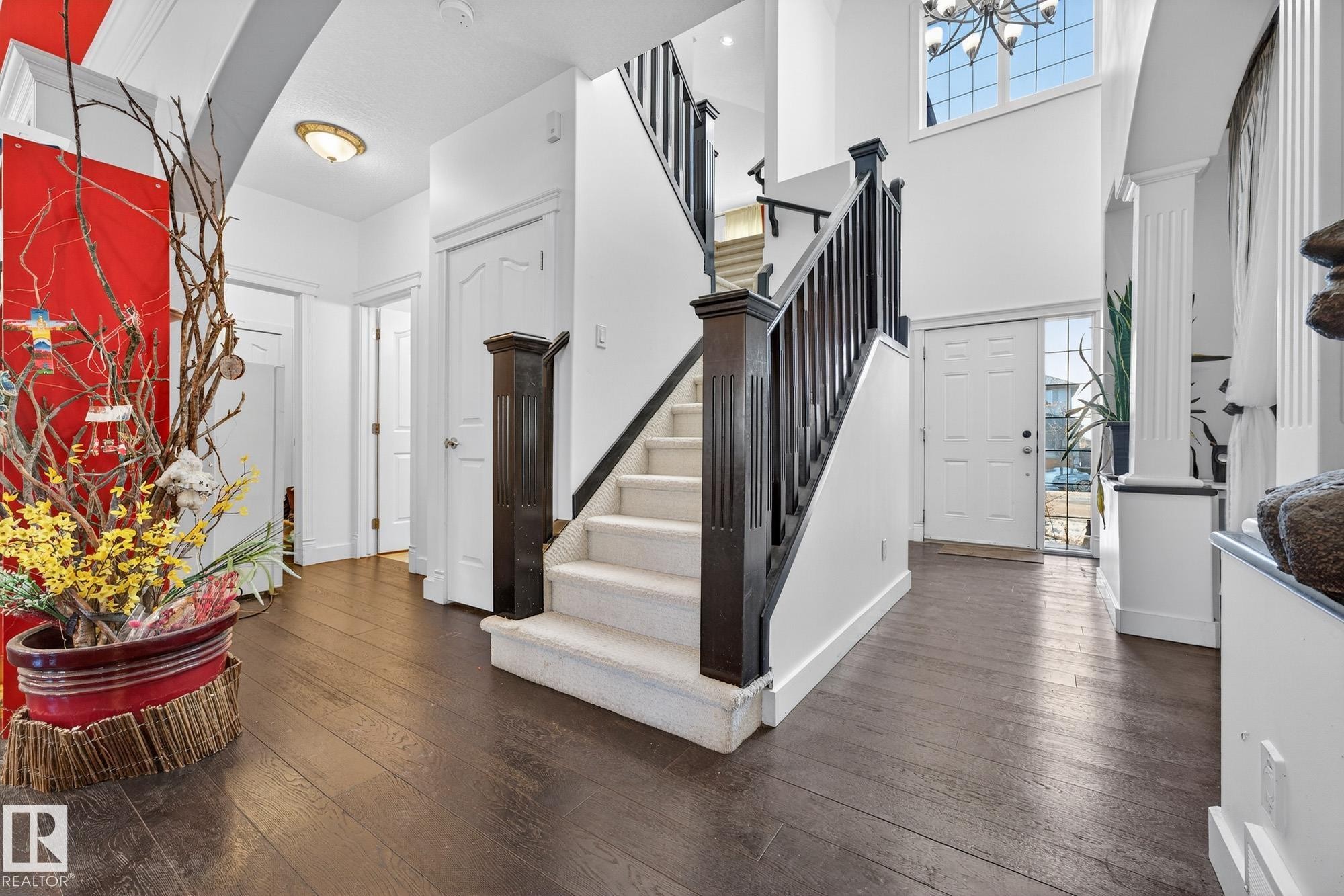 Entrance foyer with dark wood-style flooring and suspended lighting - 1660 Malone Way, Edmonton, AB