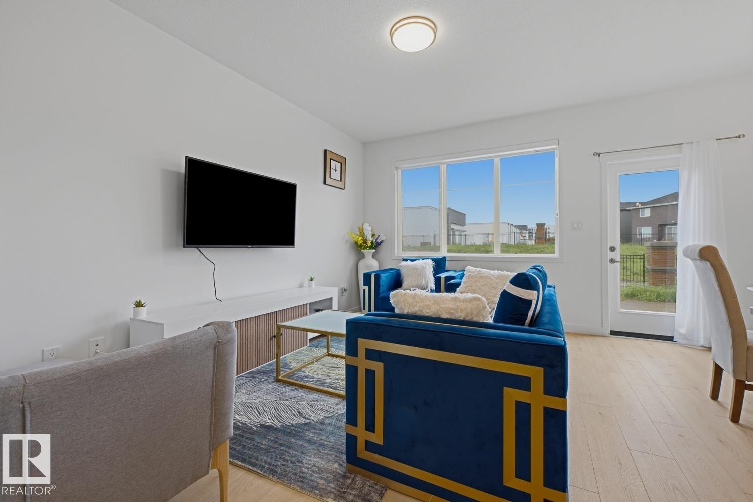 Bright living area featuring light wood-finish flooring - 22924 82 Ave Nw, Edmonton, AB - Indoor Photo Showing Living Room
