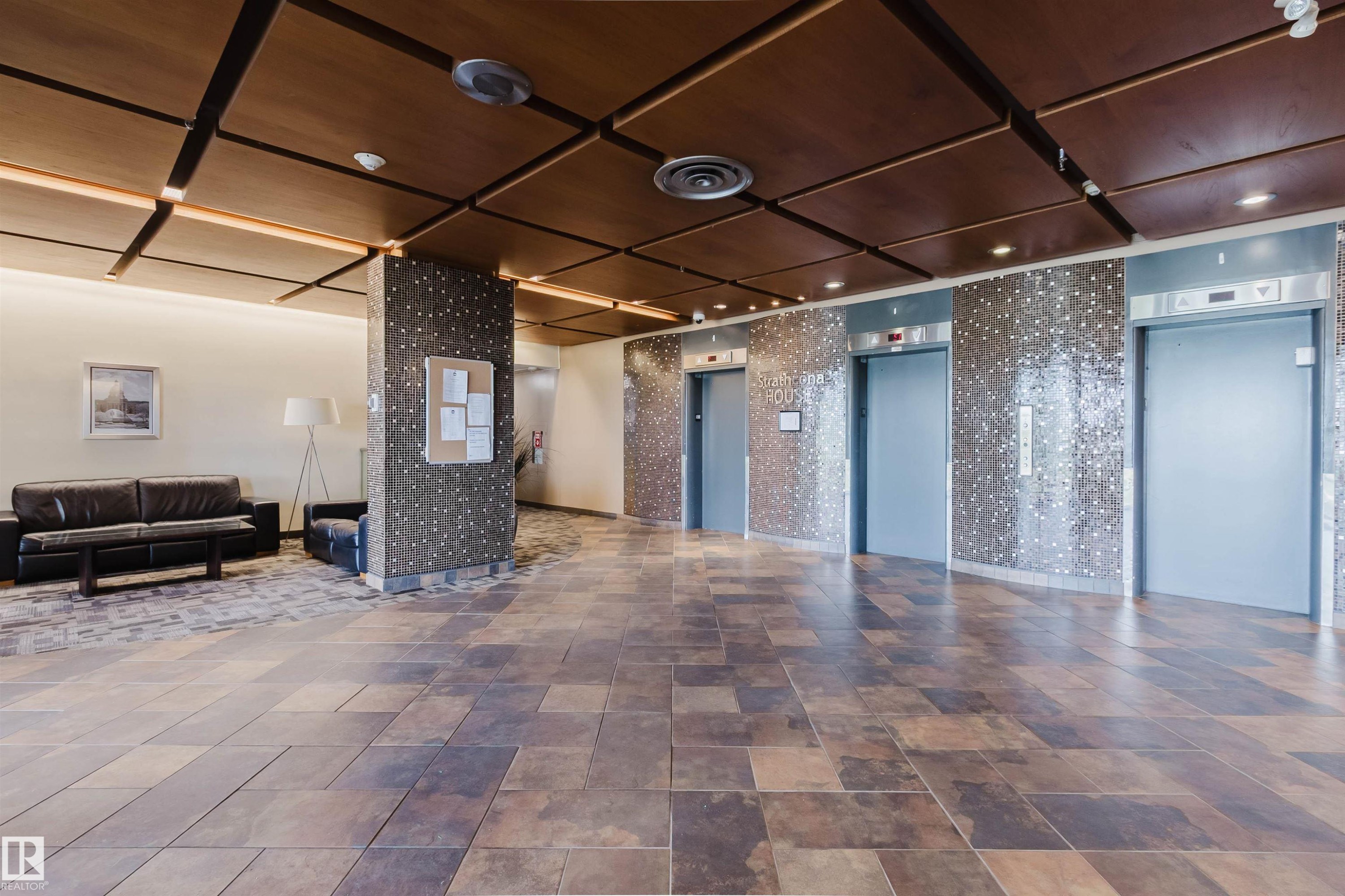 Lobby featuring multiple elevators, recessed lighting, and a wood-finish ceiling with integrated paneling - 904 10883 Saskatchewan Drive, Edmonton, AB
