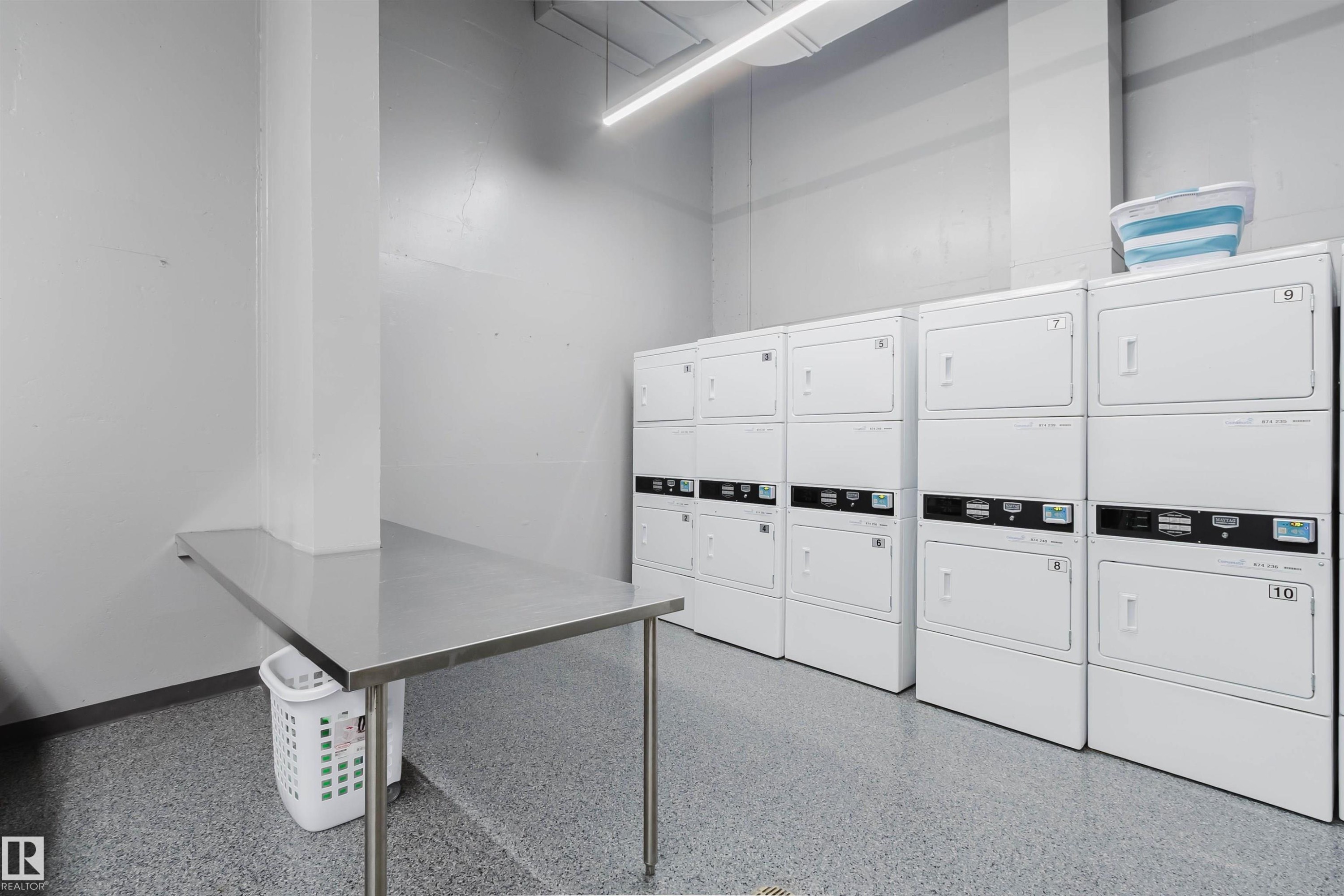 On-site laundry facility featuring multiple stackable washer/dryer units - 904 10883 Saskatchewan Drive, Edmonton, AB