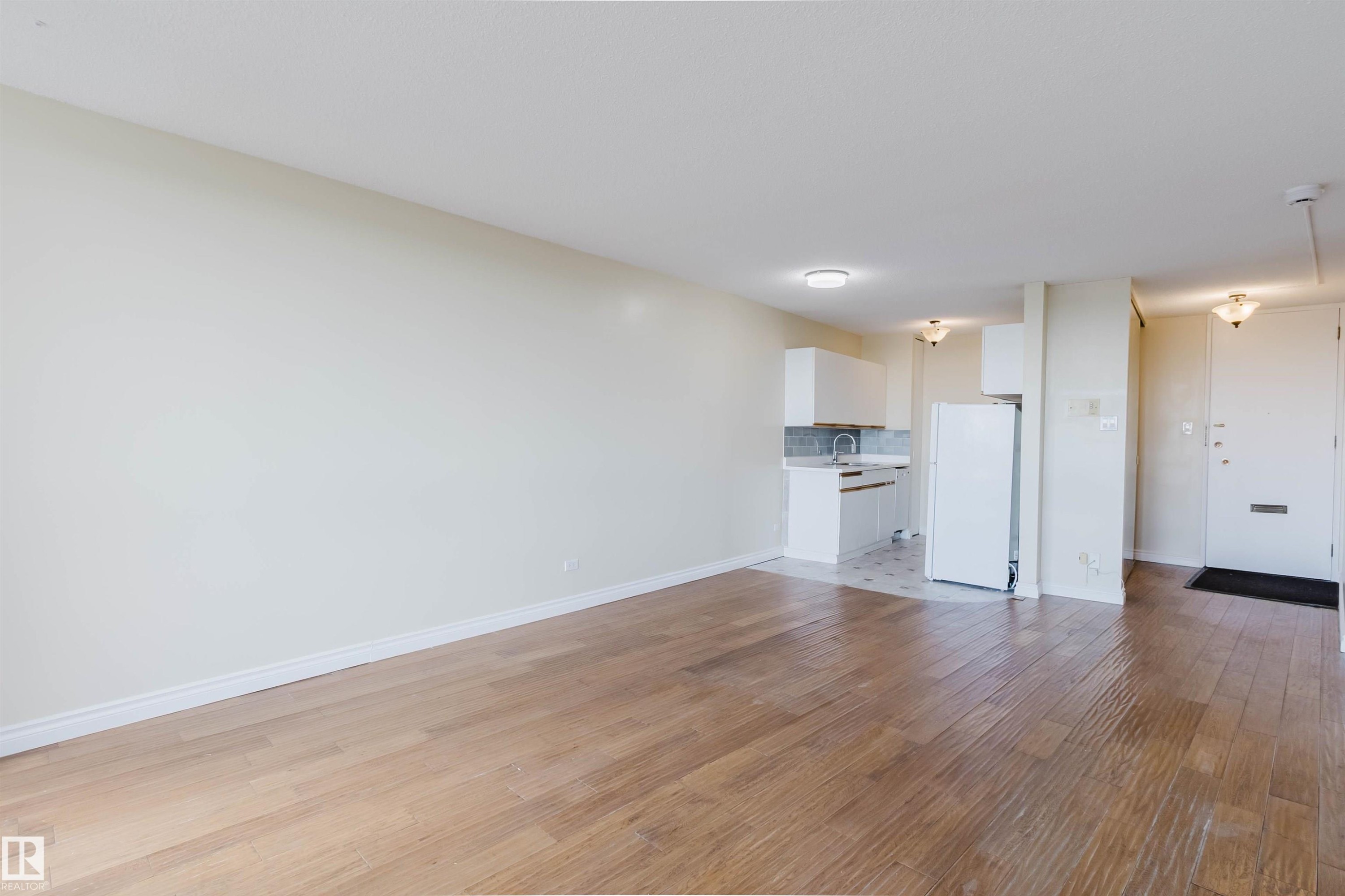 Spacious main living area featuring wood-finish flooring - 904 10883 Saskatchewan Drive, Edmonton, AB