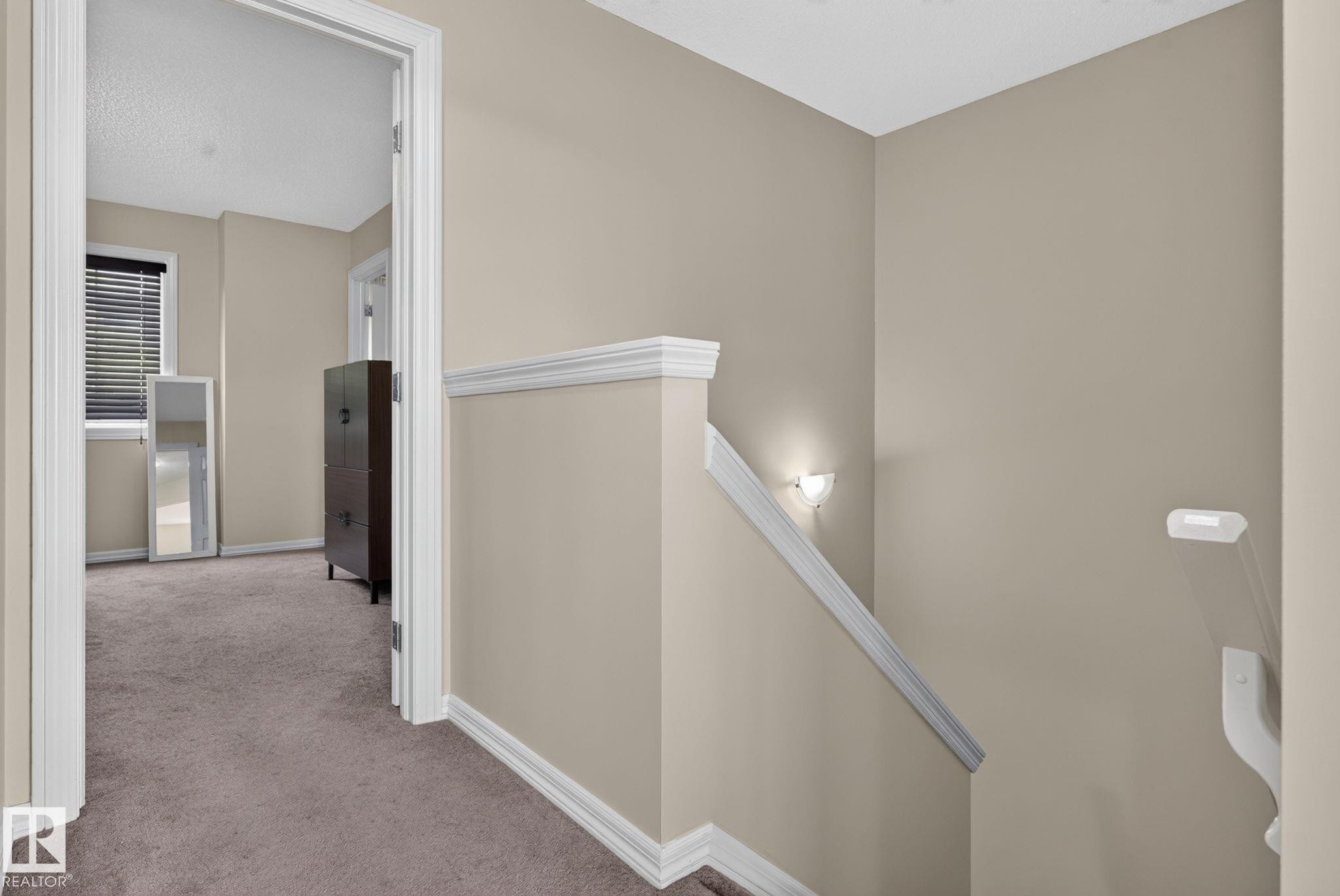 Upper-level hallway featuring neutral wall paint, white trim, and plush carpet flooring - 545 Watt Boulevard Sw, Edmonton, AB - Indoor Photo Showing Other Room