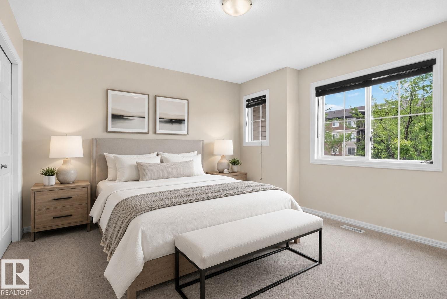 Carpeted bedroom featuring neutral wall tones and ample natural light from multiple windows - 545 Watt Boulevard Sw, Edmonton, AB - Indoor Photo Showing Bedroom