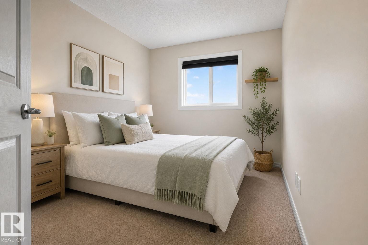 Neutral-toned bedroom featuring wall-to-wall carpeting and a white-framed window - 545 Watt Boulevard Sw, Edmonton, AB - Indoor Photo Showing Bedroom