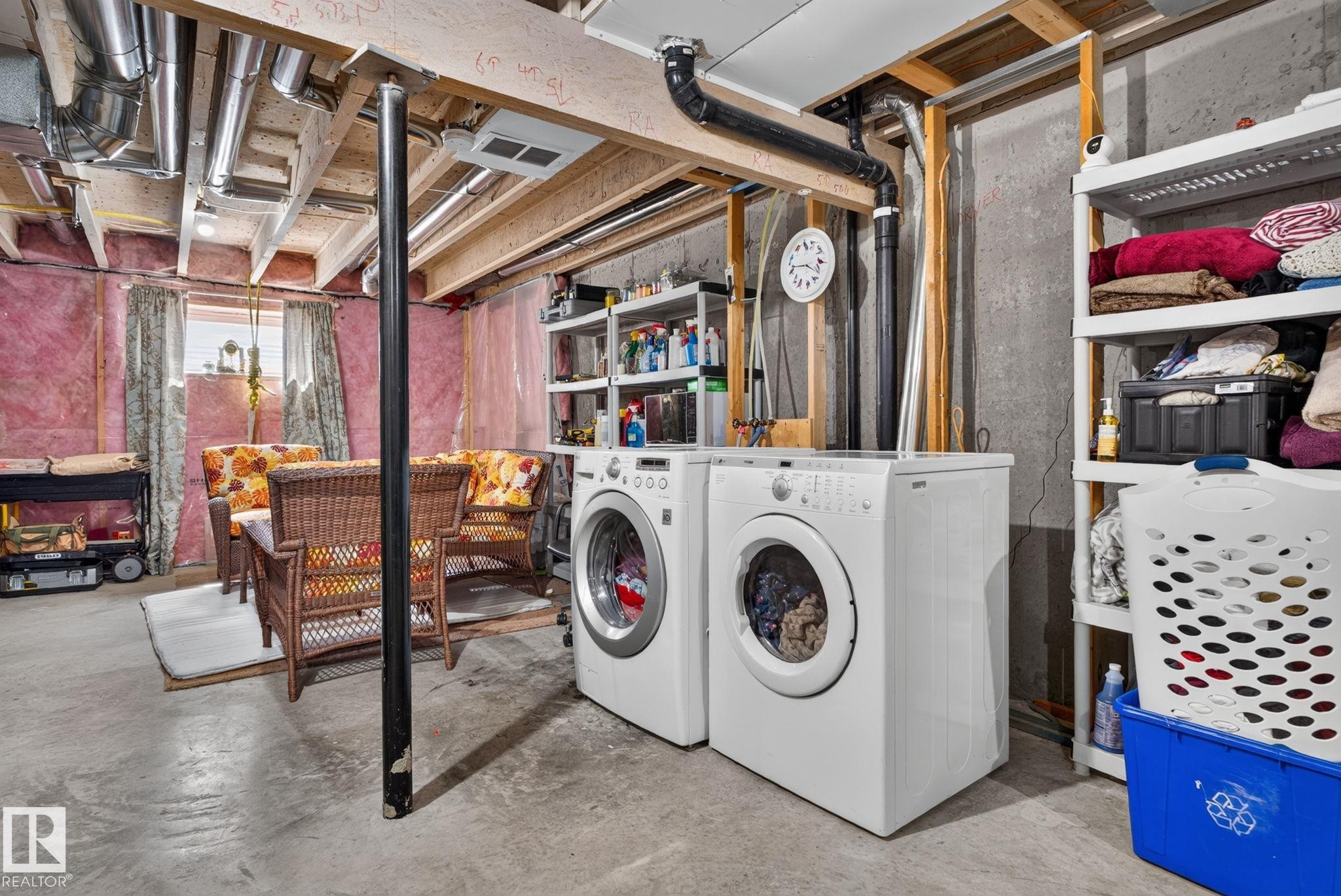 Basement utility space featuring exposed ceiling joists, ductwork, and concrete flooring - 545 Watt Boulevard Sw, Edmonton, AB - Indoor Photo Showing Laundry Room