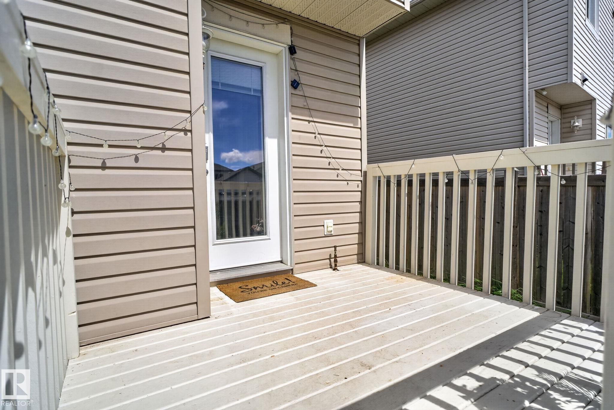 Expansive outdoor deck featuring wood-finish flooring and a white railing - 545 Watt Boulevard Sw, Edmonton, AB - Outdoor With Exterior