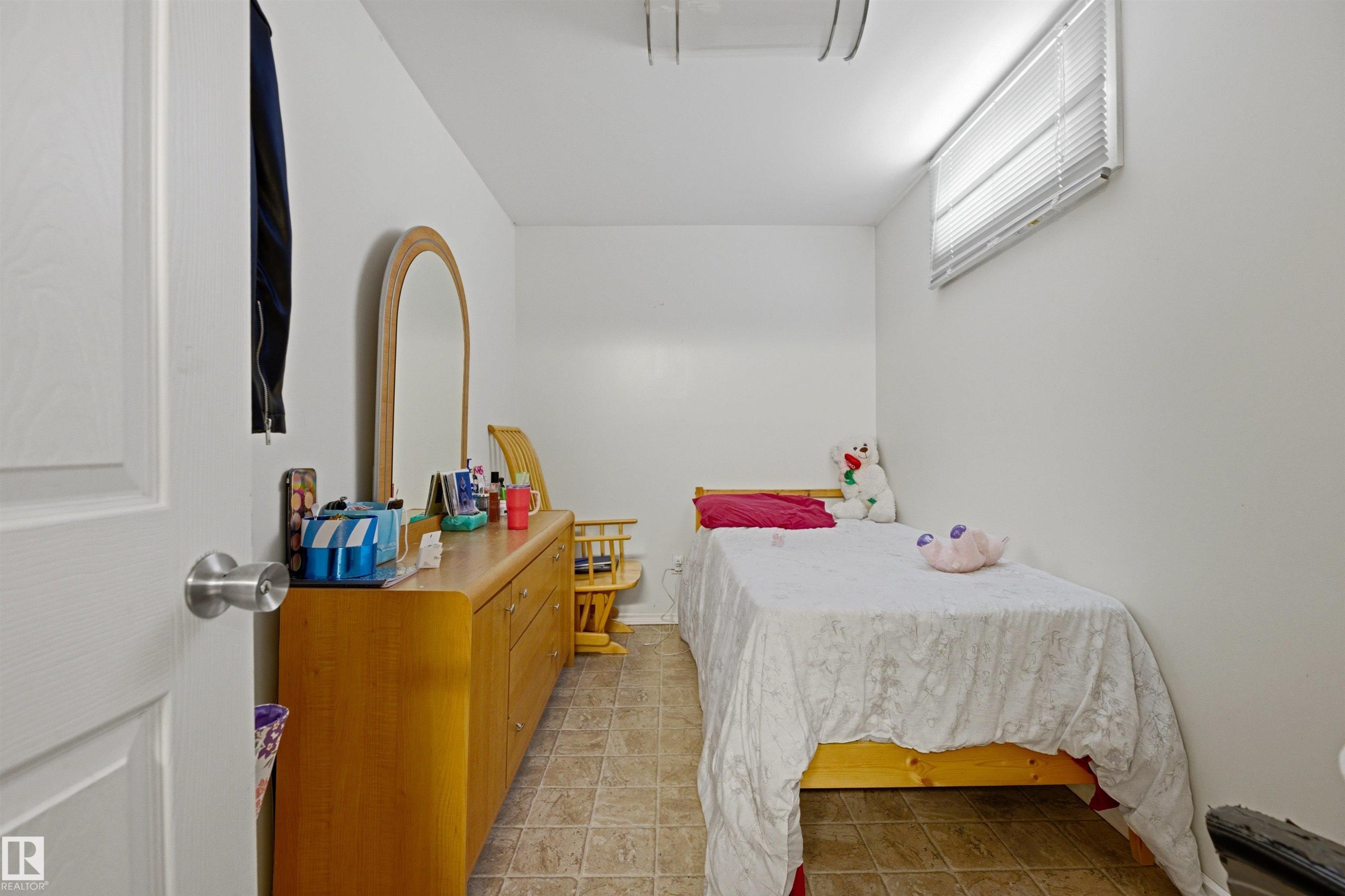 Compact room featuring white walls and neutral-toned tile flooring - 8911 169 Street Nw, Edmonton, AB - Indoor Photo Showing Bedroom