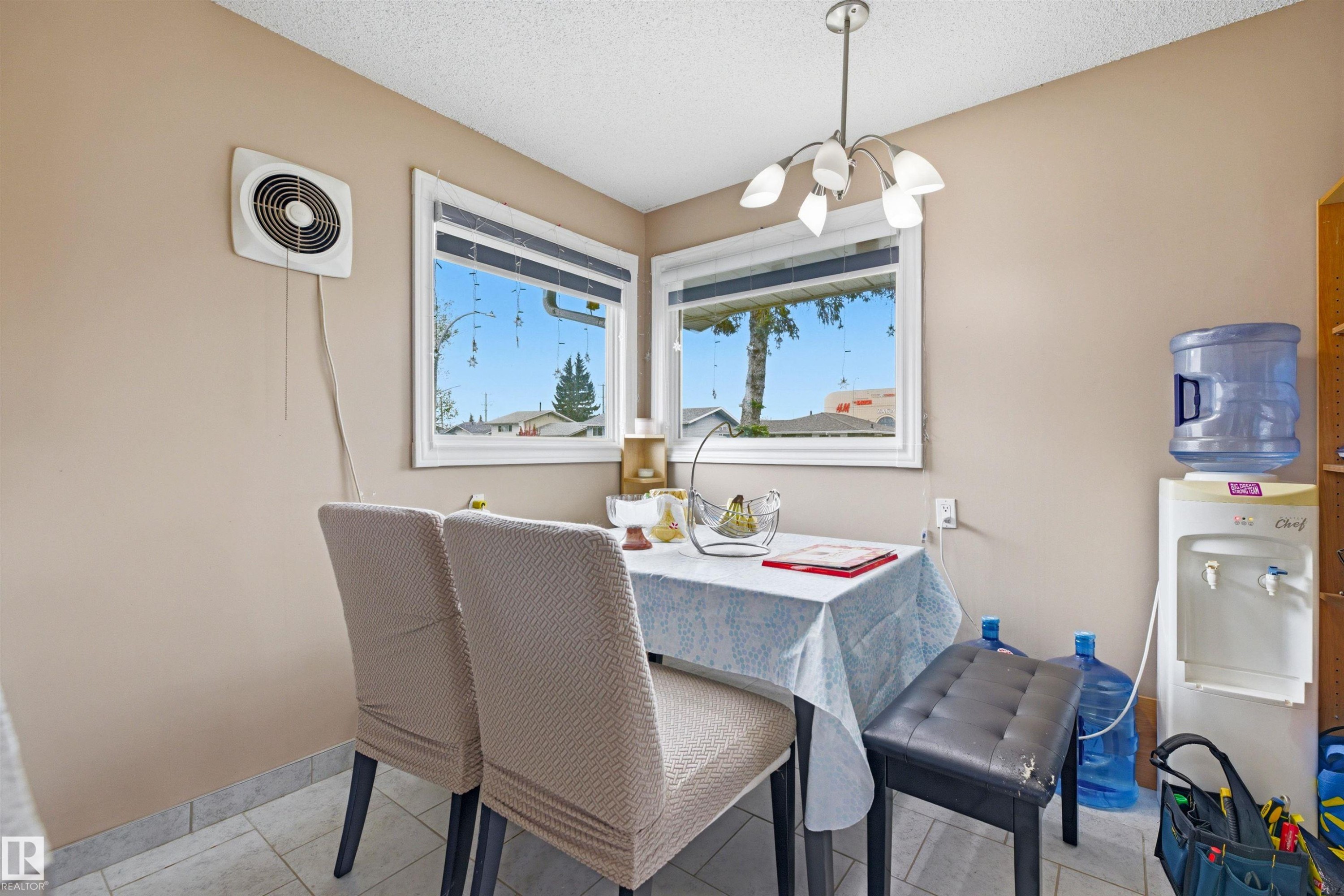 Dining area featuring tiled flooring, neutral wall paint, and a contemporary ceiling light fixture - 8911 169 Street Nw, Edmonton, AB - Indoor Photo Showing Dining Room