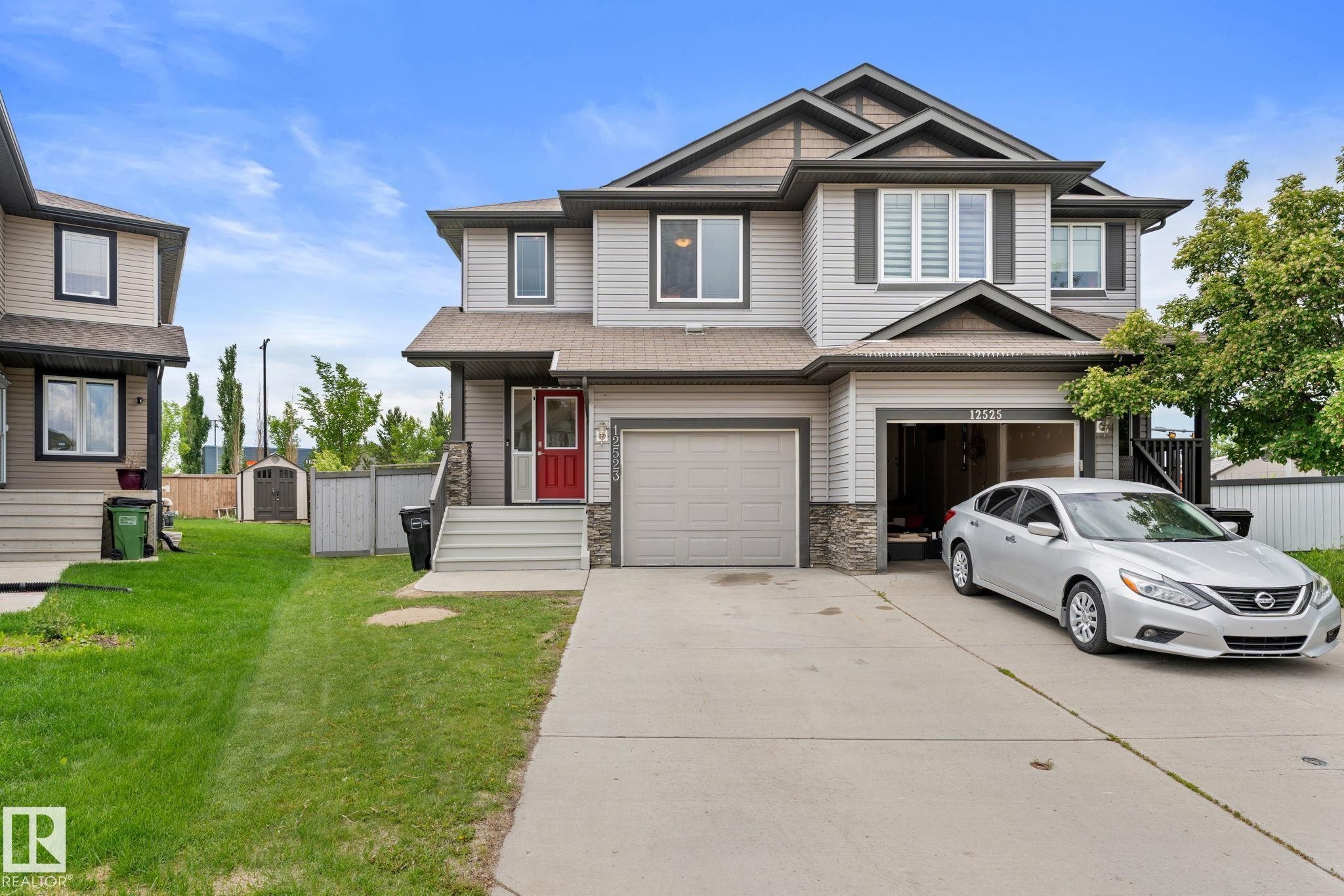 Two-story residence featuring light gray siding, stone accents, and dark trim - 12523 171 Avenue, Edmonton, AB