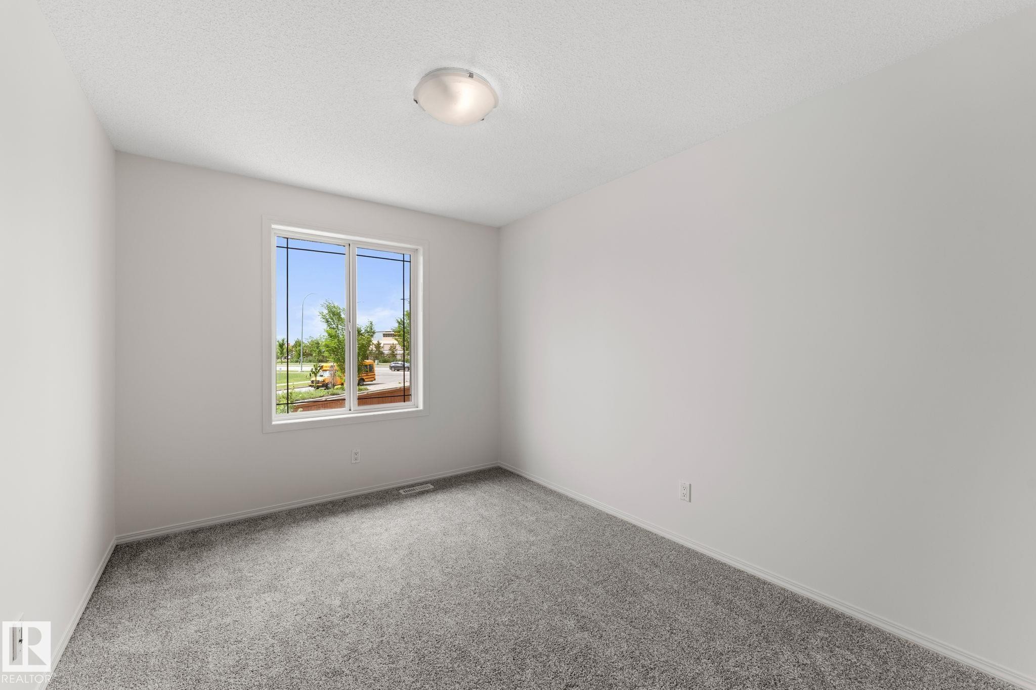 Bright interior room with grey carpeting and white walls - 12523 171 Avenue, Edmonton, AB