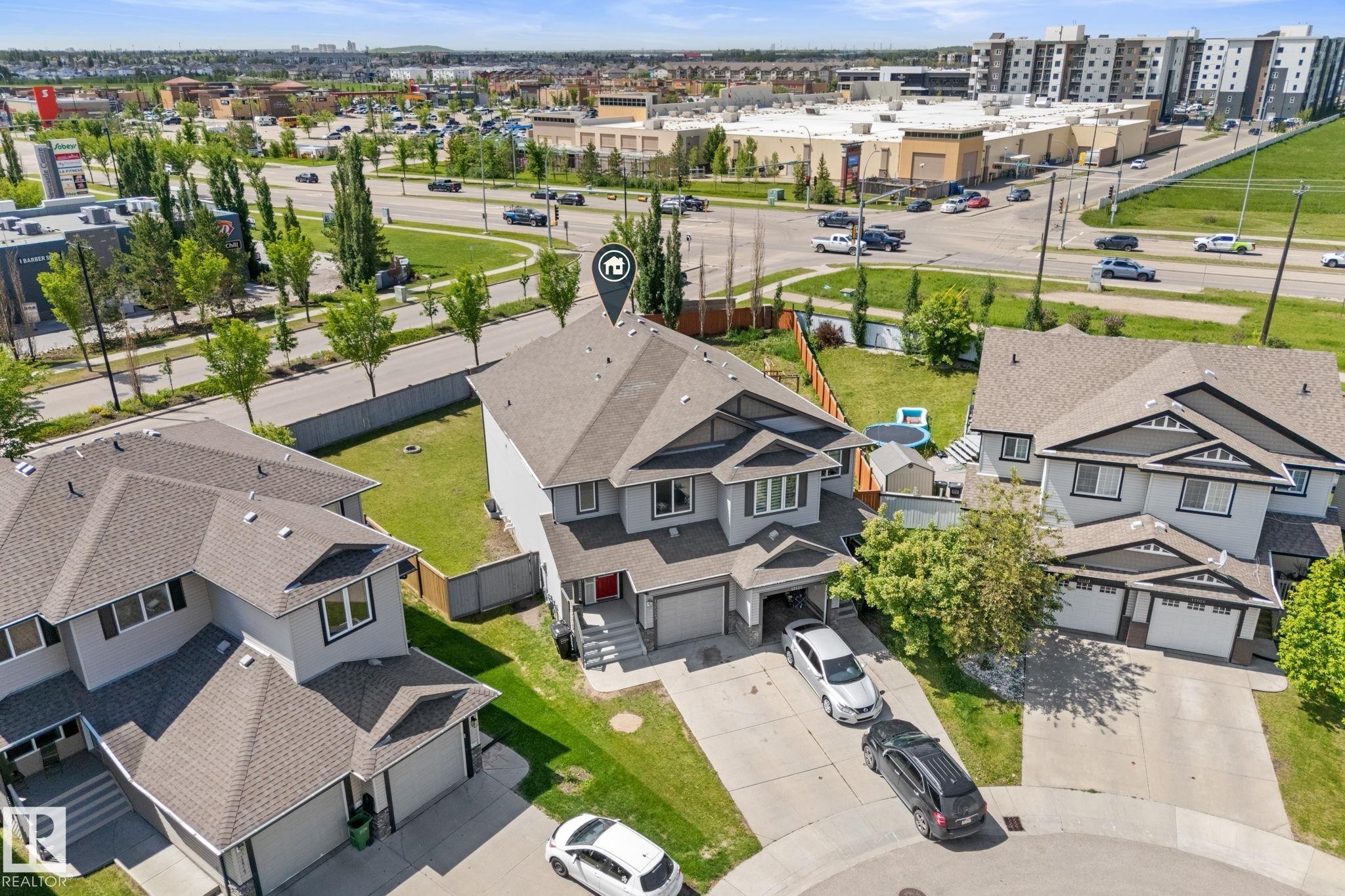 Contemporary two-story residence featuring a neutral grey exterior and dark trim accents - 12523 171 Avenue, Edmonton, AB