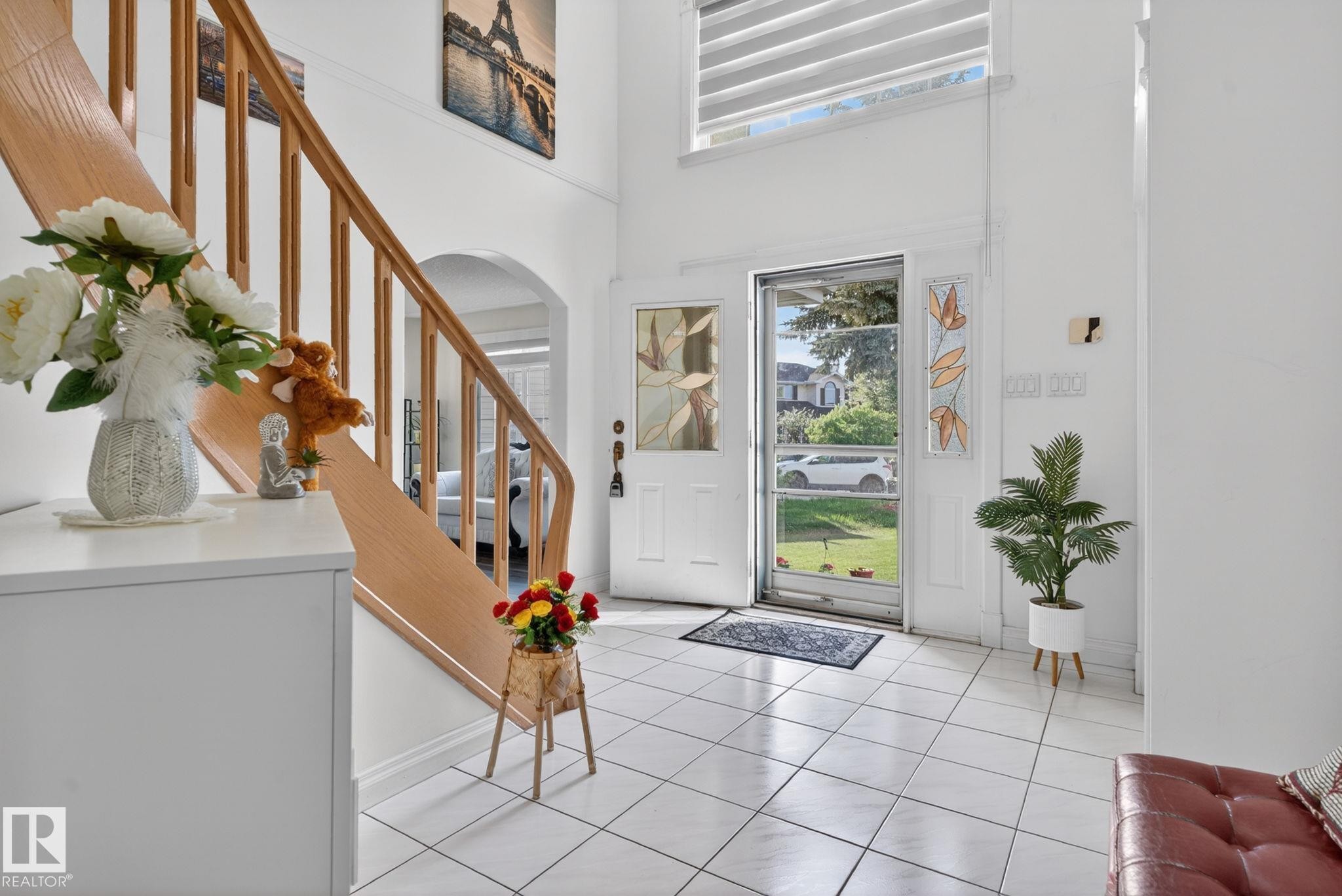 Entry foyer featuring tile flooring and a light wood staircase with balusters - 4615 43A Avenue, Edmonton, AB - Indoor Photo Showing Other Room