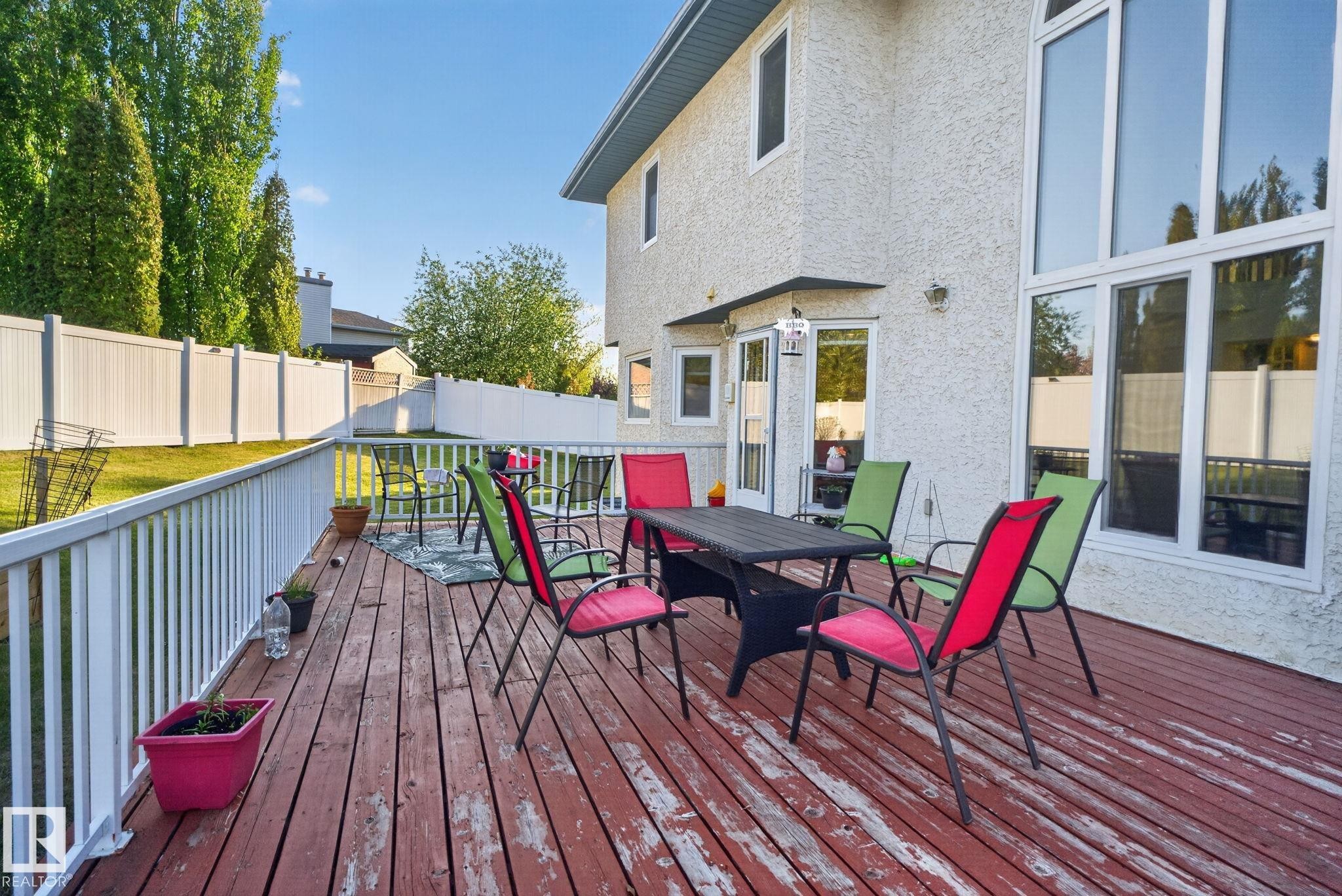Expansive wood-finish deck with white railing system - 4615 43A Avenue, Edmonton, AB - Outdoor With Deck Patio Veranda With Exterior