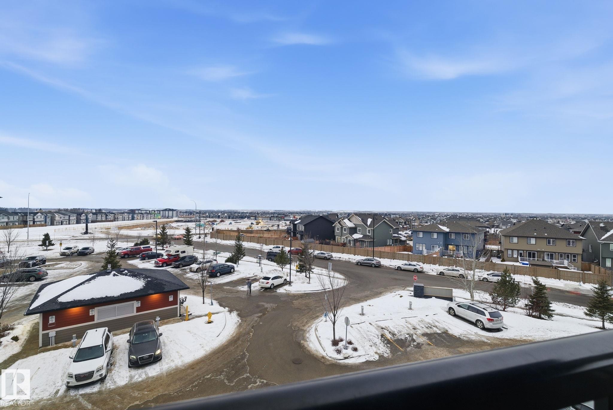 Expansive neighborhood setting featuring a public park, residential homes, and open land - 424 1510 Watt Drive, Edmonton, AB