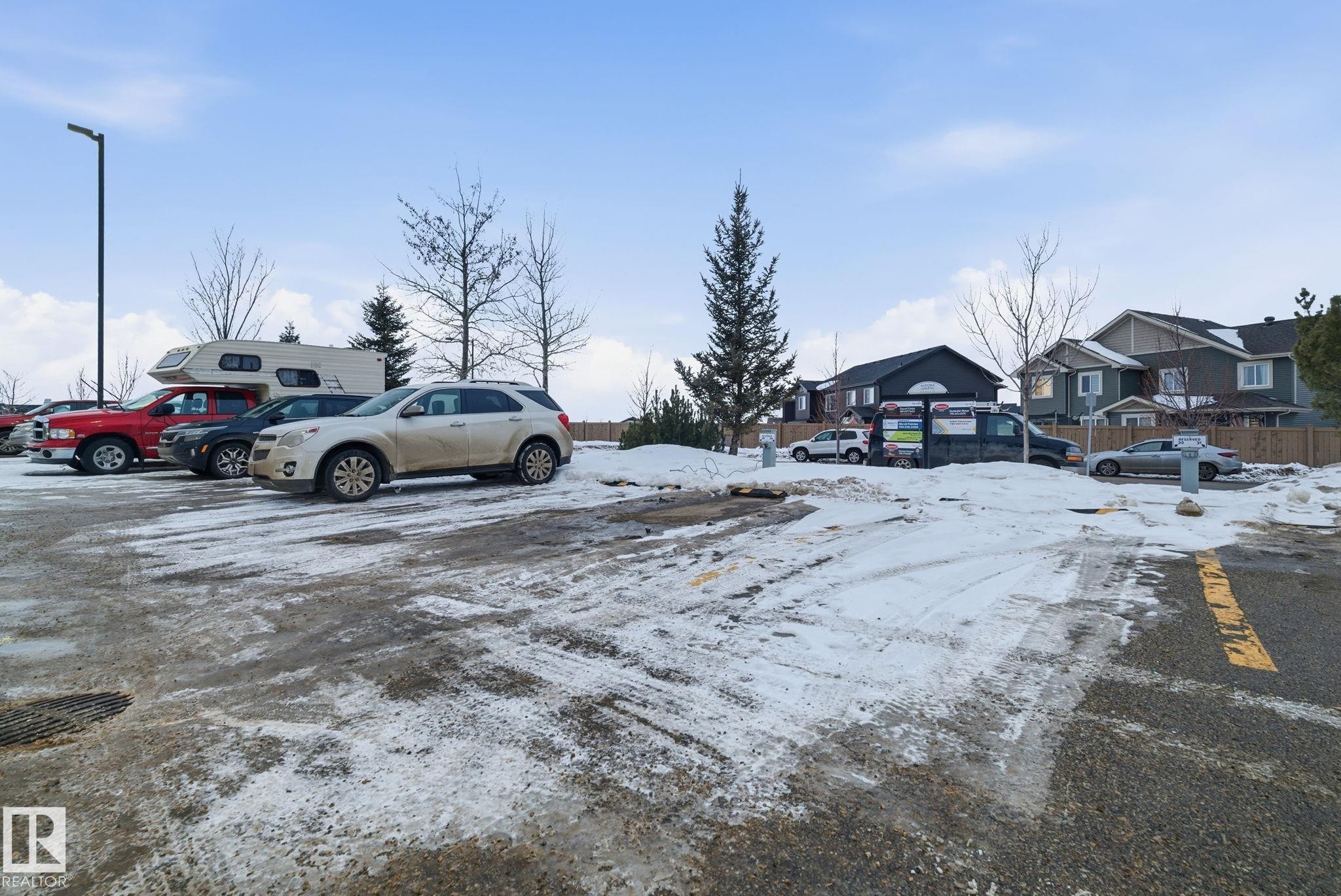 Paved parking area with visible yellow line markings - 424 1510 Watt Drive, Edmonton, AB
