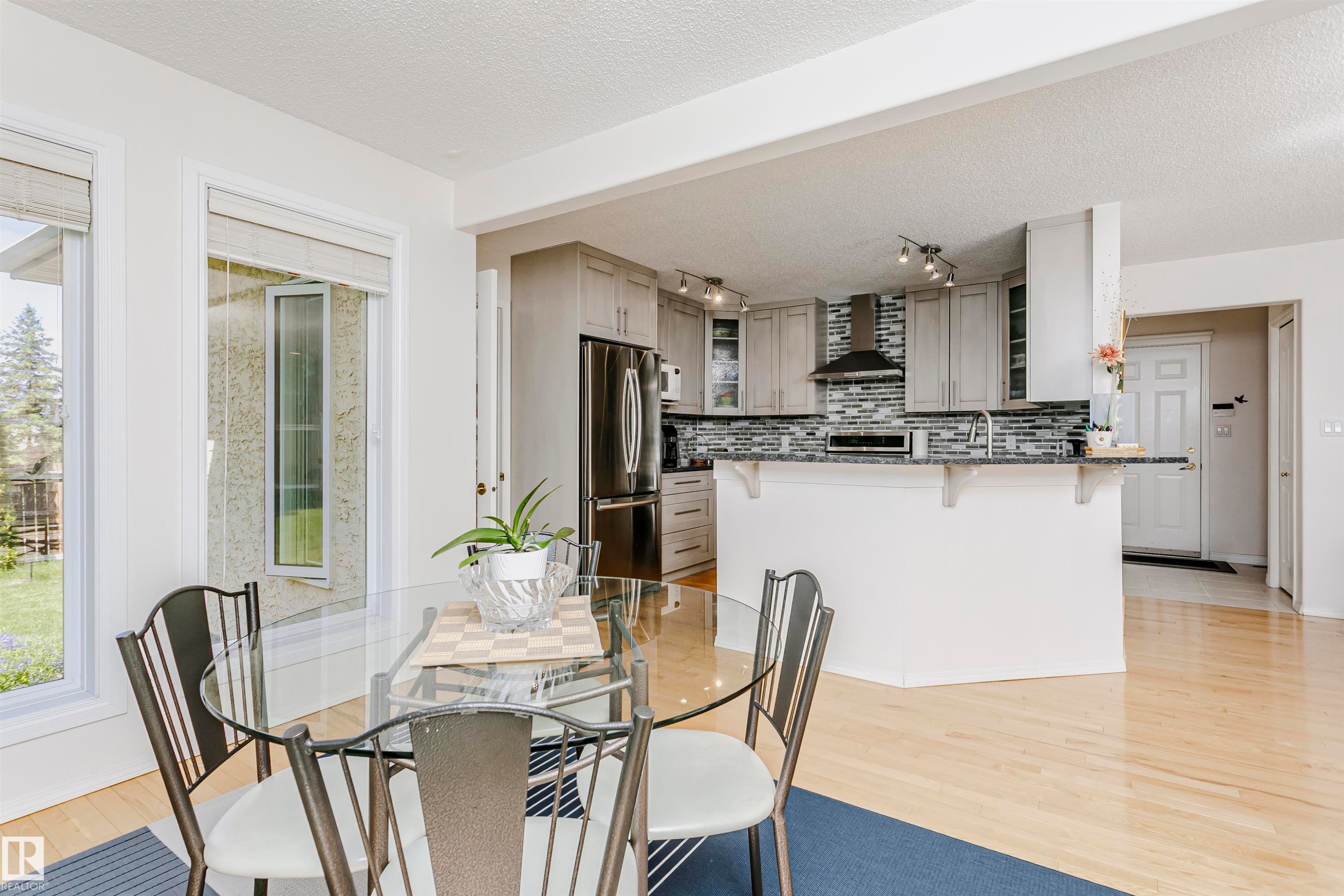 Open concept living space featuring light wood-finish flooring - 11023 11A Avenue Nw, Edmonton, AB - Indoor Photo Showing Dining Room