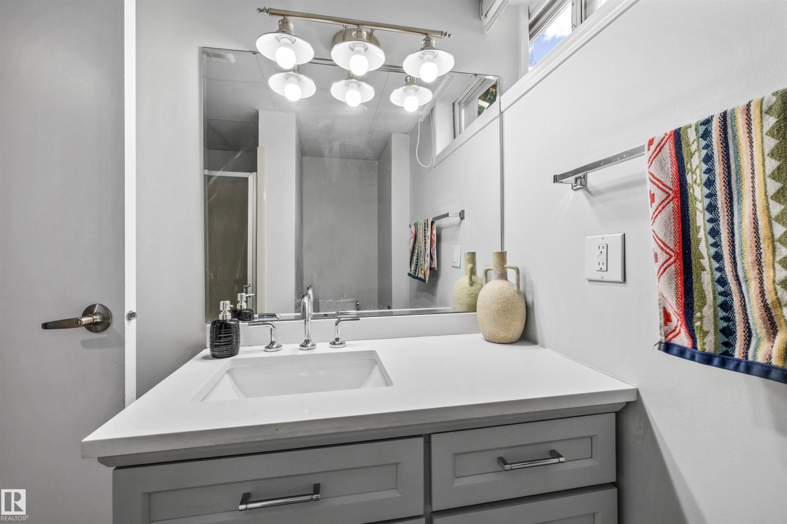 Modern bathroom vanity featuring a rectangular undermount sink and polished chrome faucet - 10130 62 Street, Edmonton, AB - Indoor Photo Showing Bathroom