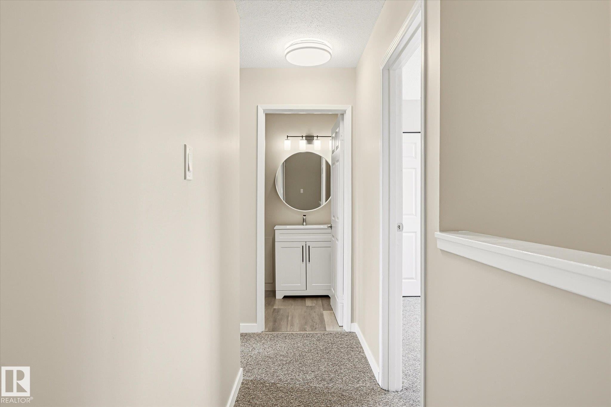 Hallway featuring neutral wall tones, carpet flooring, and a flush mount ceiling light - 186 Cornell Crest, Edmonton, AB