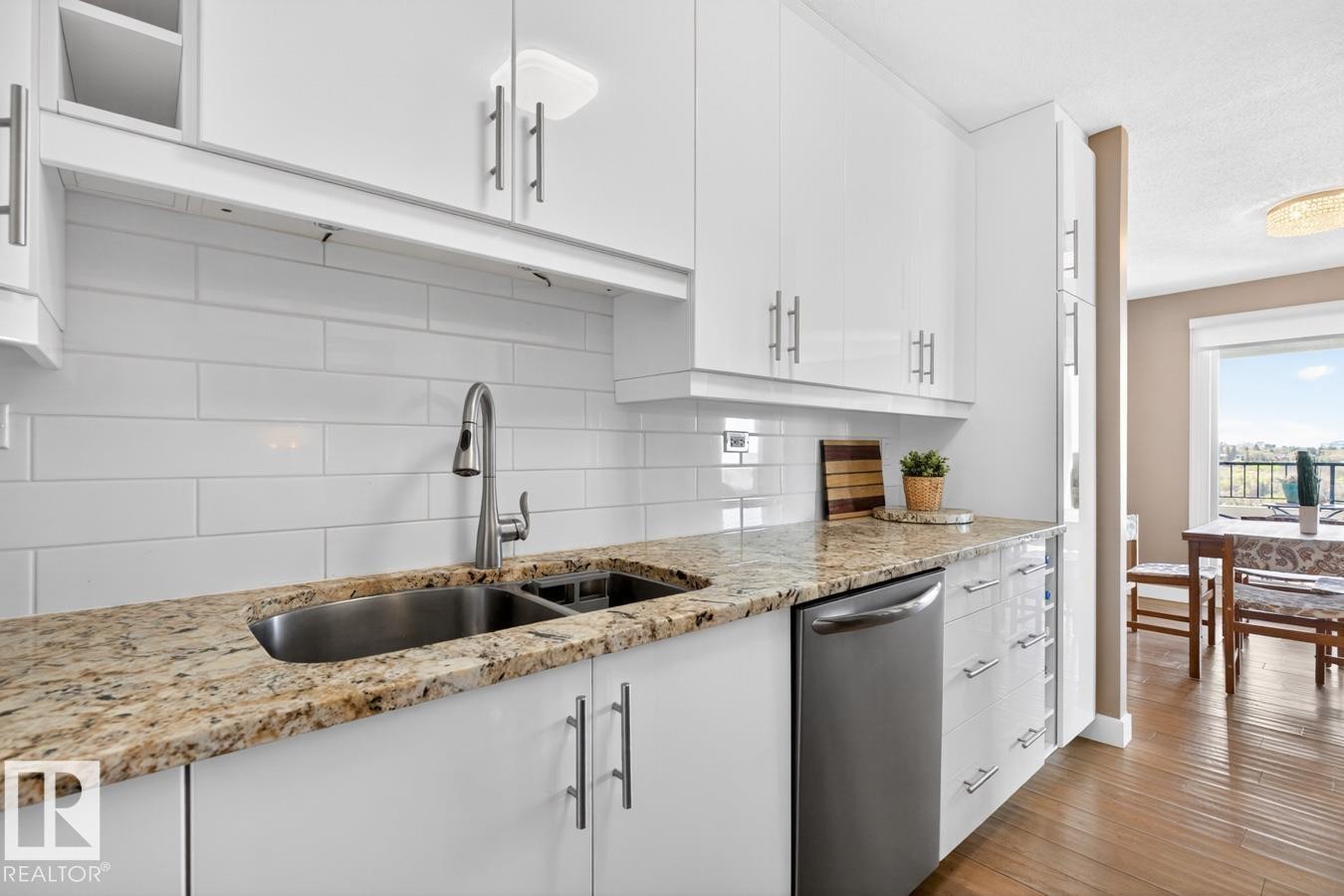 Updated White Kitchen Cabinets with Granite Counter Tops and Stainless Steel Appliances. Pass through window next to your front entrance makes dropping off groceries a breeze! - 602 12303 Jasper Avenue, Edmonton, AB