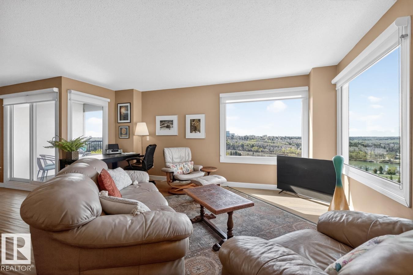 Large living room space perfect for relaxing next to South and West Facing picturesque windows overlooking the River Valley, Golf Course, and City Skyline. - 602 12303 Jasper Avenue, Edmonton, AB