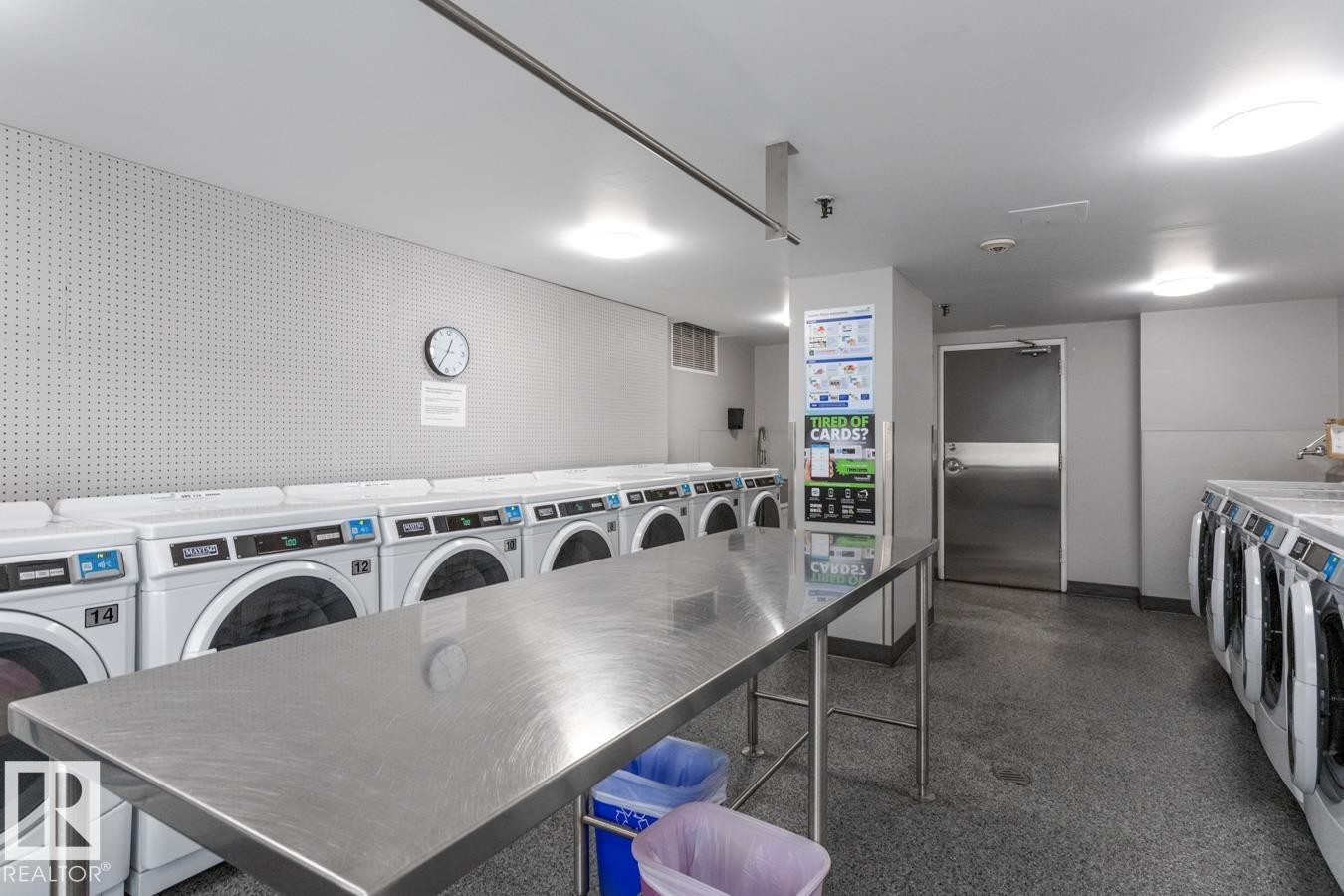 Building laundry room featuring multiple washing machines and dryers. There are multiple floors with laundry rooms - get more loads done at once! - 602 12303 Jasper Avenue, Edmonton, AB