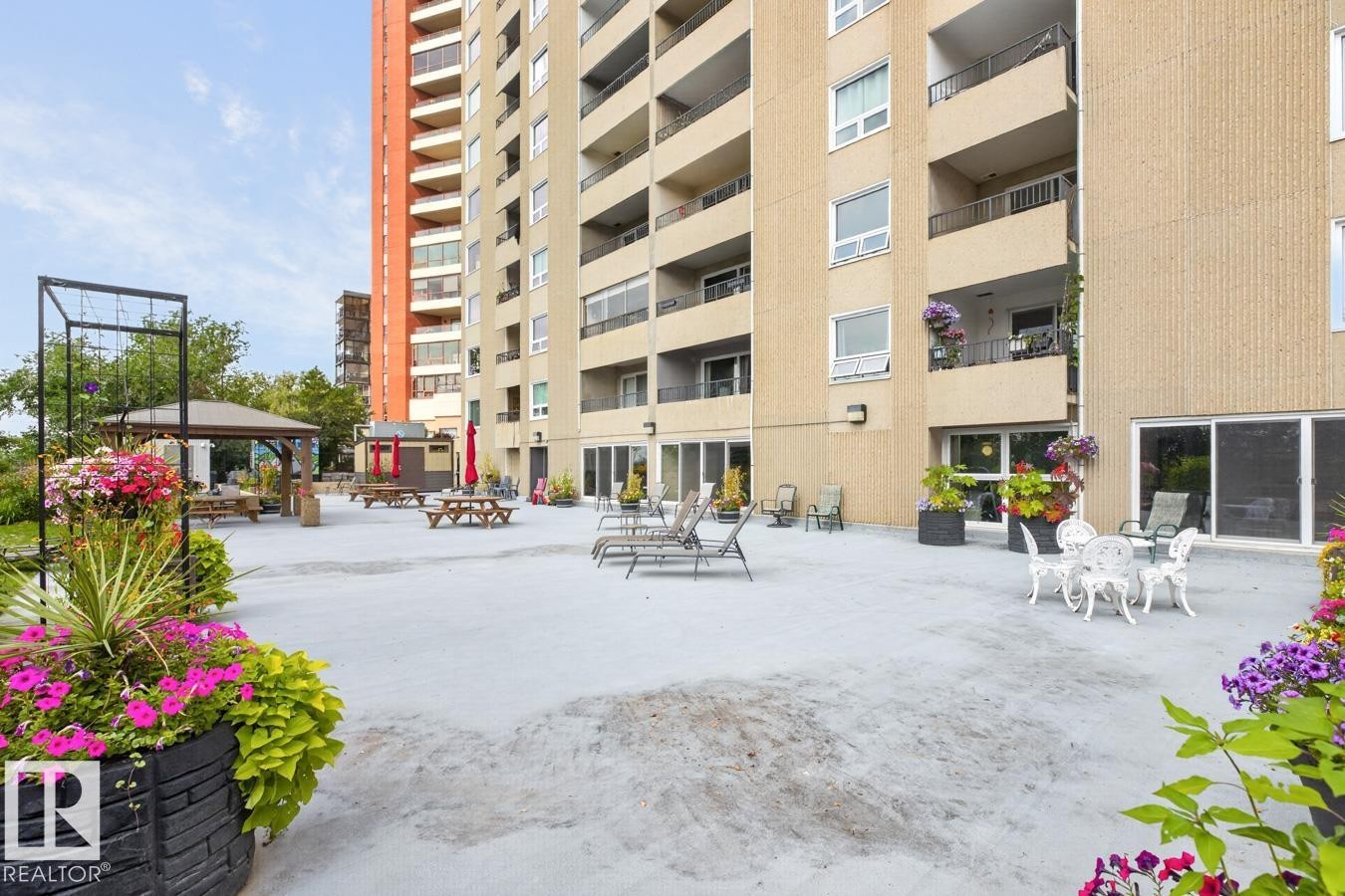 What if you want to take that party outside? No problem! Lounge chairs, picnic tables, gazebo and garden and 3 BBQ’s! - #602 12303 Jasper Av Nw, Edmonton, AB - Outdoor With Balcony