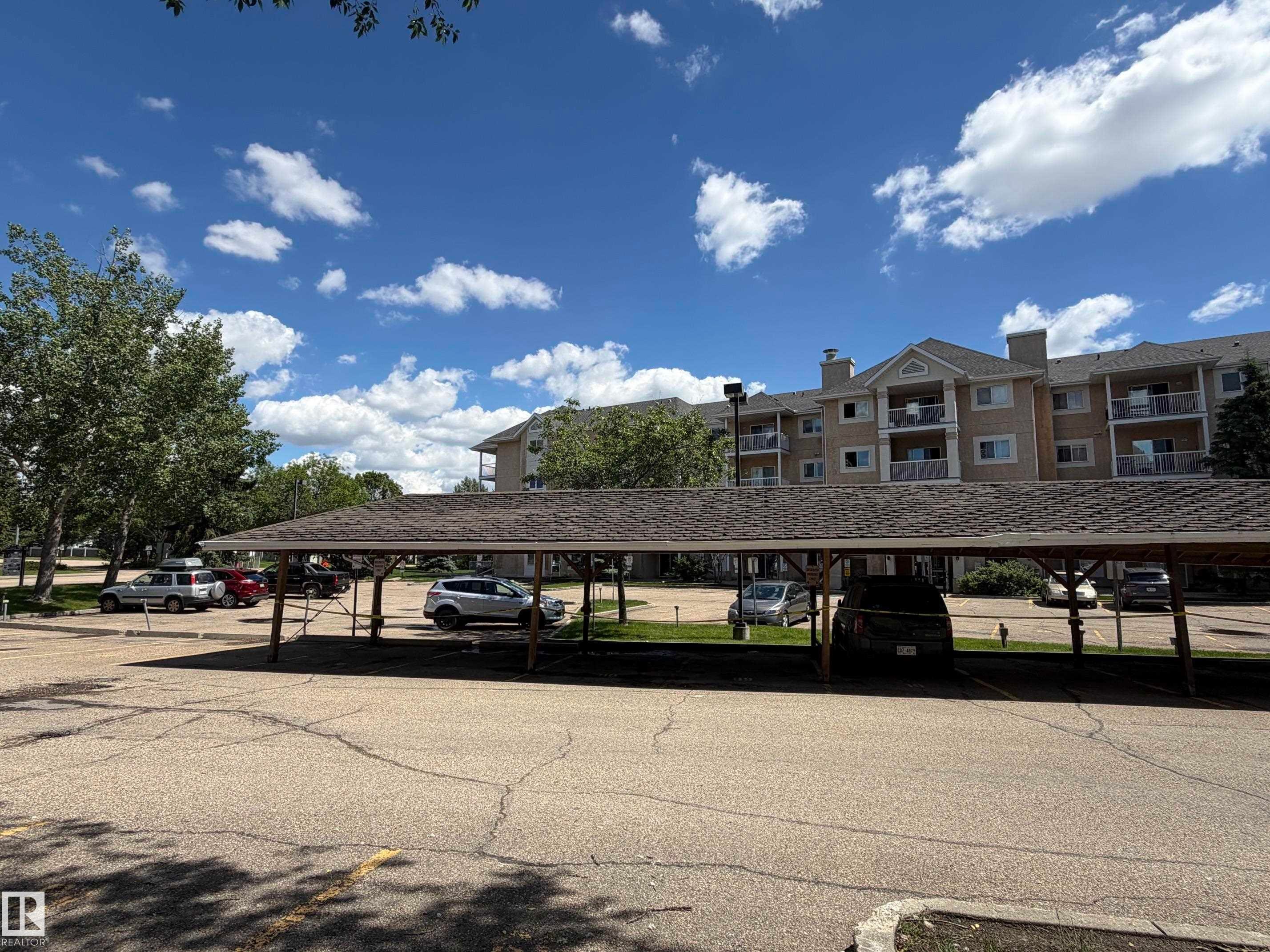 Multi-story building featuring multiple balconies and a covered parking structure - 213 17467 98A Avenue, Edmonton, AB