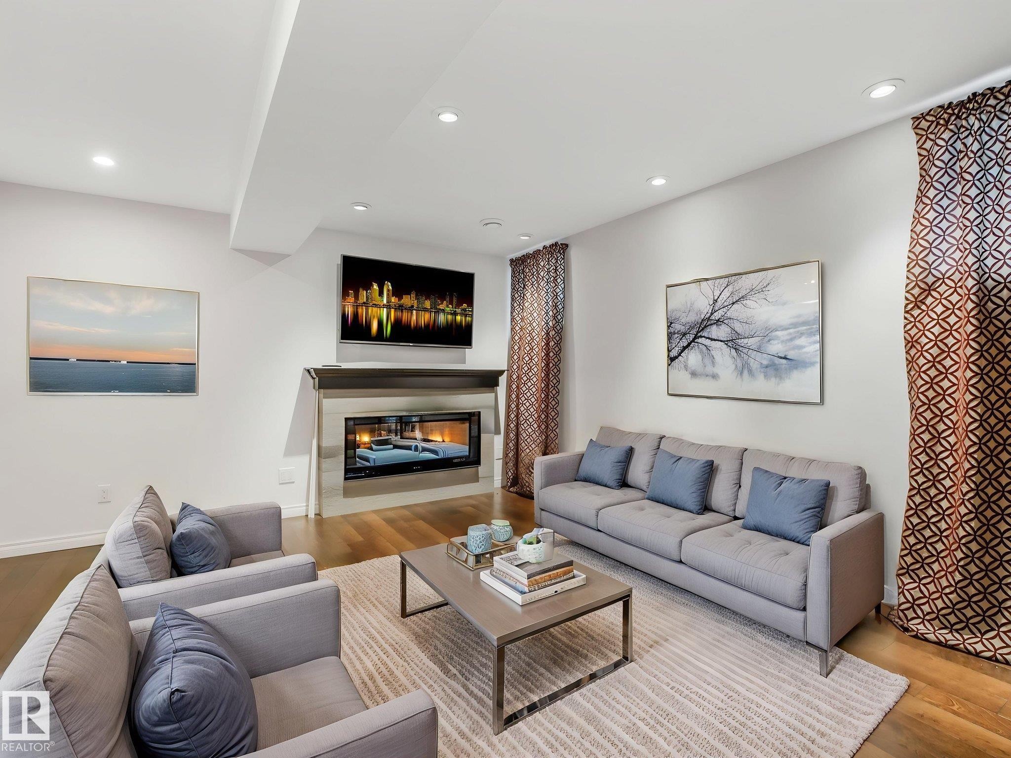 Second living room for entertaining in the basement has electric fireplace and TV can stay. - 14843 140 Street, Edmonton, AB