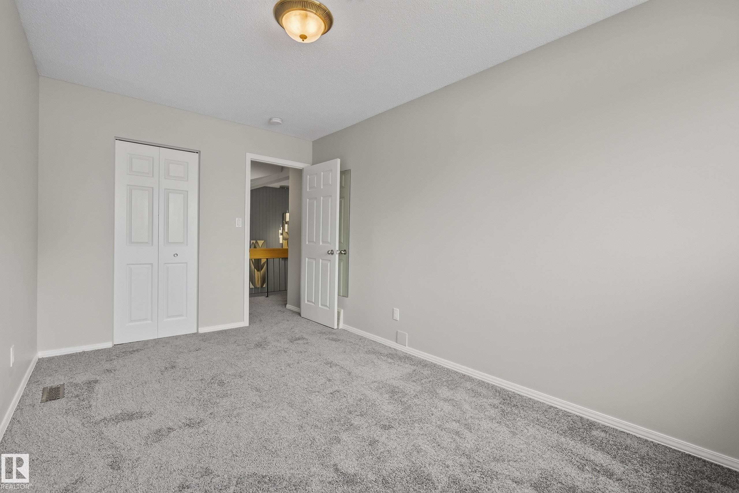 Neutral gray wall color with white trim and gray carpeting - 2712 104 Street, Edmonton, AB
